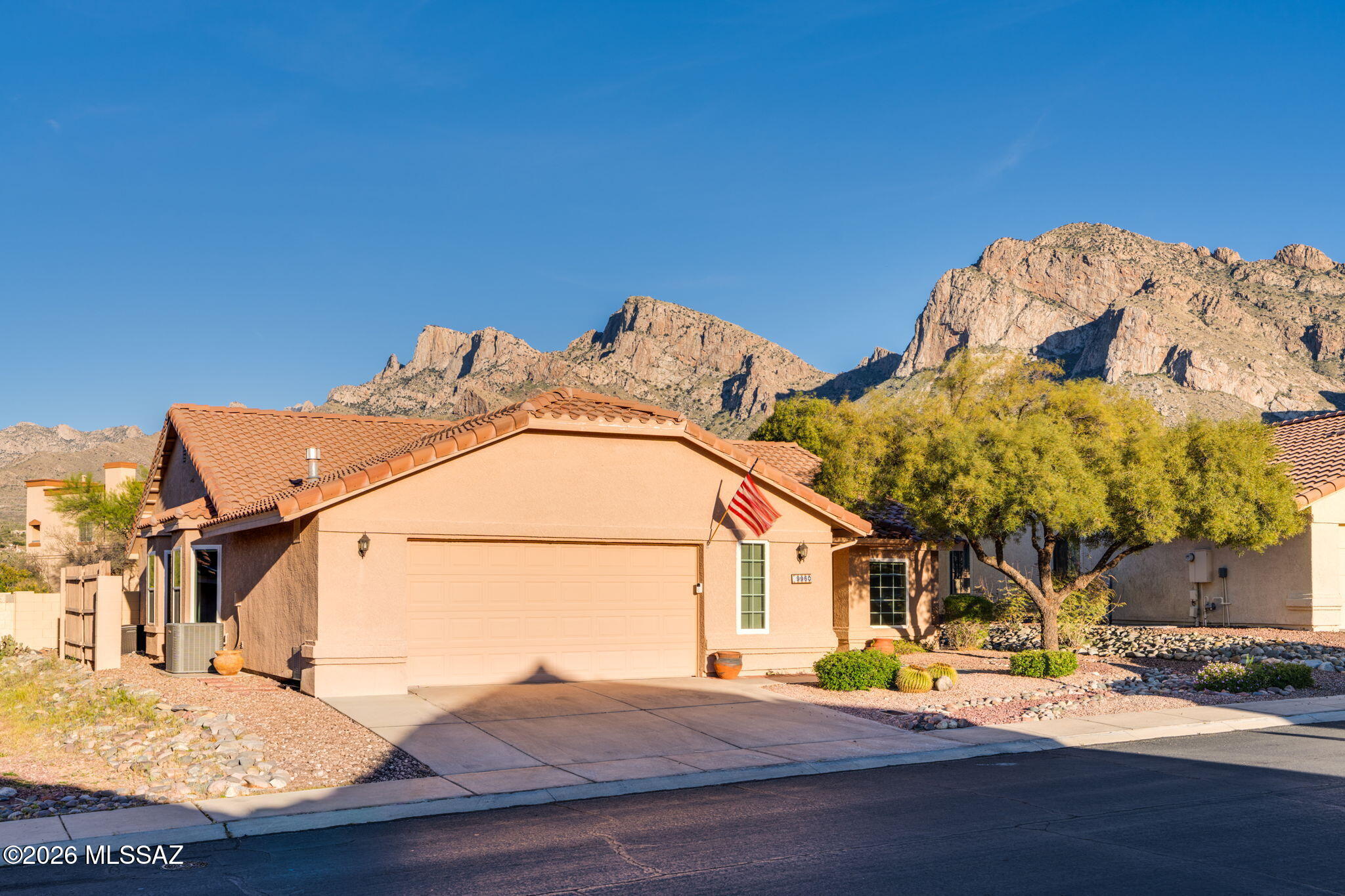 Move-in ready home in the heart of Oro Valley, nestled within the prestigious Oro Valley Country Club and offering no rear neighbors plus stunning Catalina Mountain views. Fresh interior paint and tile flooring throughout create a clean, modern feel. This spacious home features 4 bedrooms, 2 bathrooms, and a 2.5-car garage complete with a utility sink. The generous primary suite includes dual sinks, a beautifully tiled shower, and a large walk-in closet. The kitchen opens seamlessly to the family room and includes an eat-in breakfast nook and stainless-steel appliances. Enjoy cozy evenings in the family room with a gas fireplace, while separate formal living and dining areas provide additional space for entertaining. Step outside to a backyard featuring breathtaking Catalina Mountain views, a fountain, built-in gas BBQ, and added privacy with no rear neighbors. Located in the highly regarded Amphitheater Public Schools district, this home is just steps from Oro Valley Country Club and El Conquistador Hilton Resort, and minutes from shopping, dining, and outdoor recreation at Catalina State Park. A perfect blend of comfort, location, and Arizona lifestyle living.