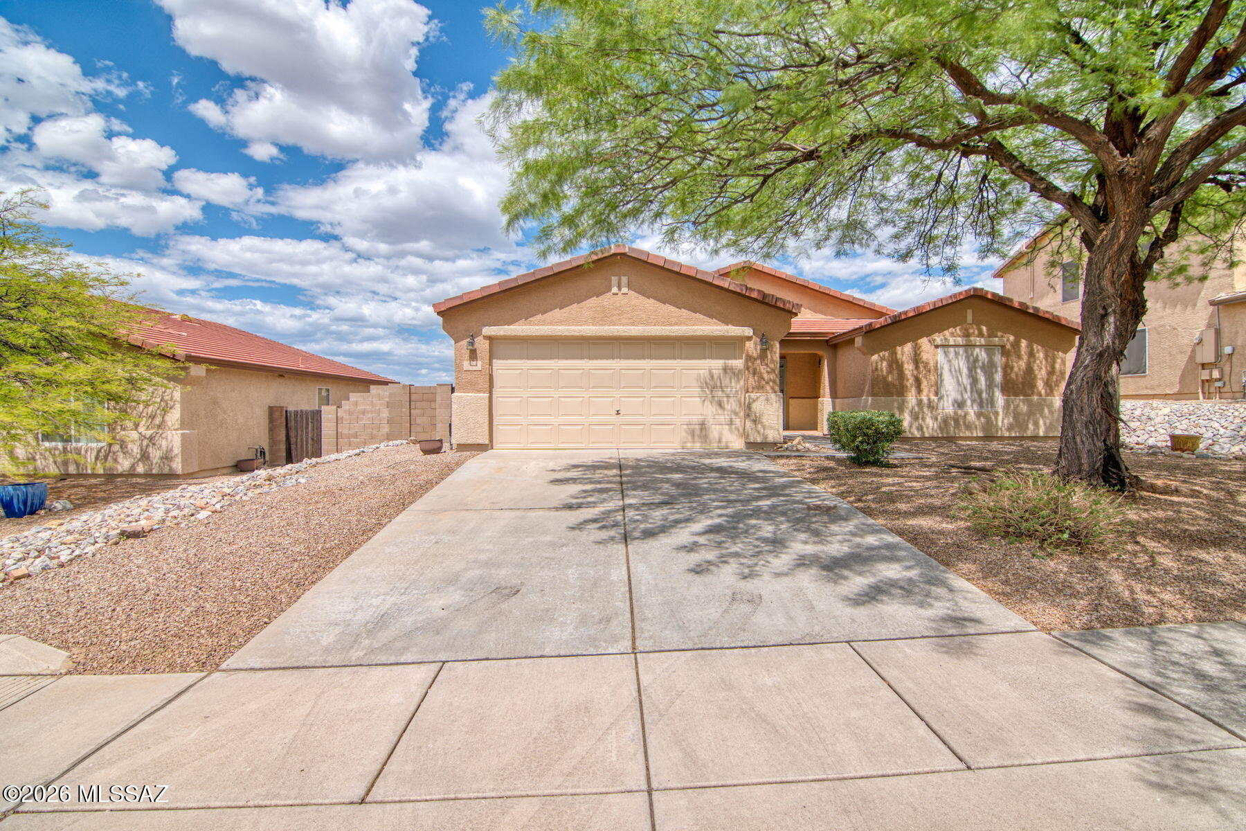Welcome to this spacious 3-bedroom, 2-bath home located in Vail, AZ, offering an open-concept layout, generous room sizes, and beautiful natural light throughout. The kitchen features an island, Corian countertops, stainless steel appliances, pull-out cabinet shelving, pantry, eat-in dining space, and electric stove.
The large primary suite includes a walk-in closet and private shower. Guest bedrooms are spacious with walk-in closets, and the guest tub/shower has never been used. Interior highlights include fresh paint, ceiling fans, tile in hallways and wet areas, carpet in common spaces, and a finished garage with storage and painted floors. Enjoy a finished backyard with covered patio, tile patio area, gravel, flagstone, view fencing, walk-through gate, walking path access and views of the old golf course. Additional upgrades include HVAC replaced approximately 3 years ago, water heater from 2018, water softener, new interior paint, exterior paint completed about 2 years ago. Washer, dryer, and refrigerator stay!