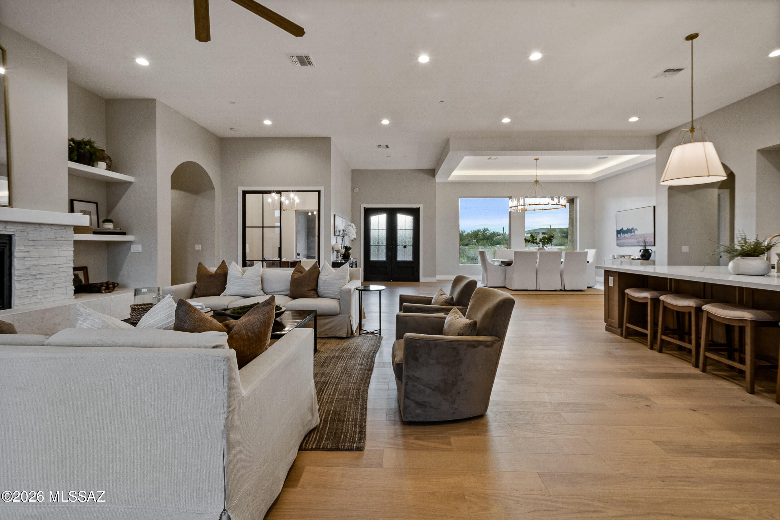UUNDER CONSTRUCTION in gated Coyote Creek, completing November 2026: a 4,032-square-foot single-level residence by Layland Homes LLC on a 1.52-acre homesite in the Rincon Valley. Great room, kitchen and dining gather beneath soaring ceilings around a gas fireplace; a multi-panel glass wall opens to the covered patio. The kitchen centers on an oversized island with professional stainless, quartz, and a butler's pantry. The primary wing has a freestanding tub, oversized tiled shower, and walk-in closet. Three en-suite secondary bedrooms, a private study, plus  Two  A/C  SYSTEMS, 14.3 SEER2  and a three-car garage complete the plan. Coyote Creek: 395 acre-plus homesites on 1,040 acres, one-story height limit, protected building envelopes. Vail School District.