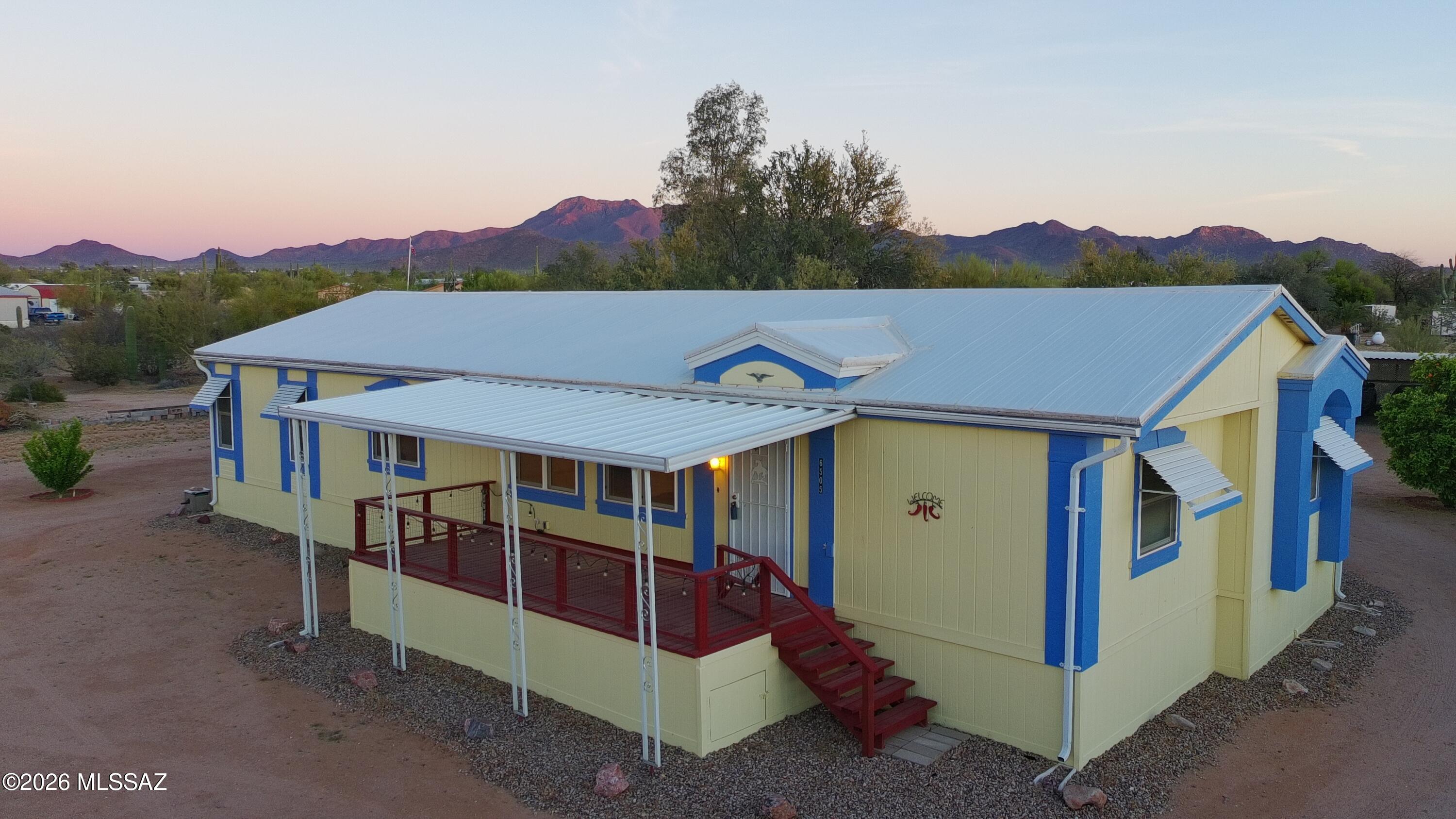 Beautifully maintained home in the desirable Picture Rocks community on a full 1-acre lot with private entrance. This property offers stunning desert landscaping and mature fruit trees, creating a peaceful and private setting. Exterior features include a two-car carport, two storage units, and a dog run. Inside, enjoy an updated kitchen and remodeled bathrooms, including a primary bath with a jetted tub and a guest bath with a walk-in tub. Additional upgrades include energy-efficient new windows and a recently replaced roof. This is a great opportunity to own a well-kept home with space, privacy, and valuable updates in a beautiful desert setting.