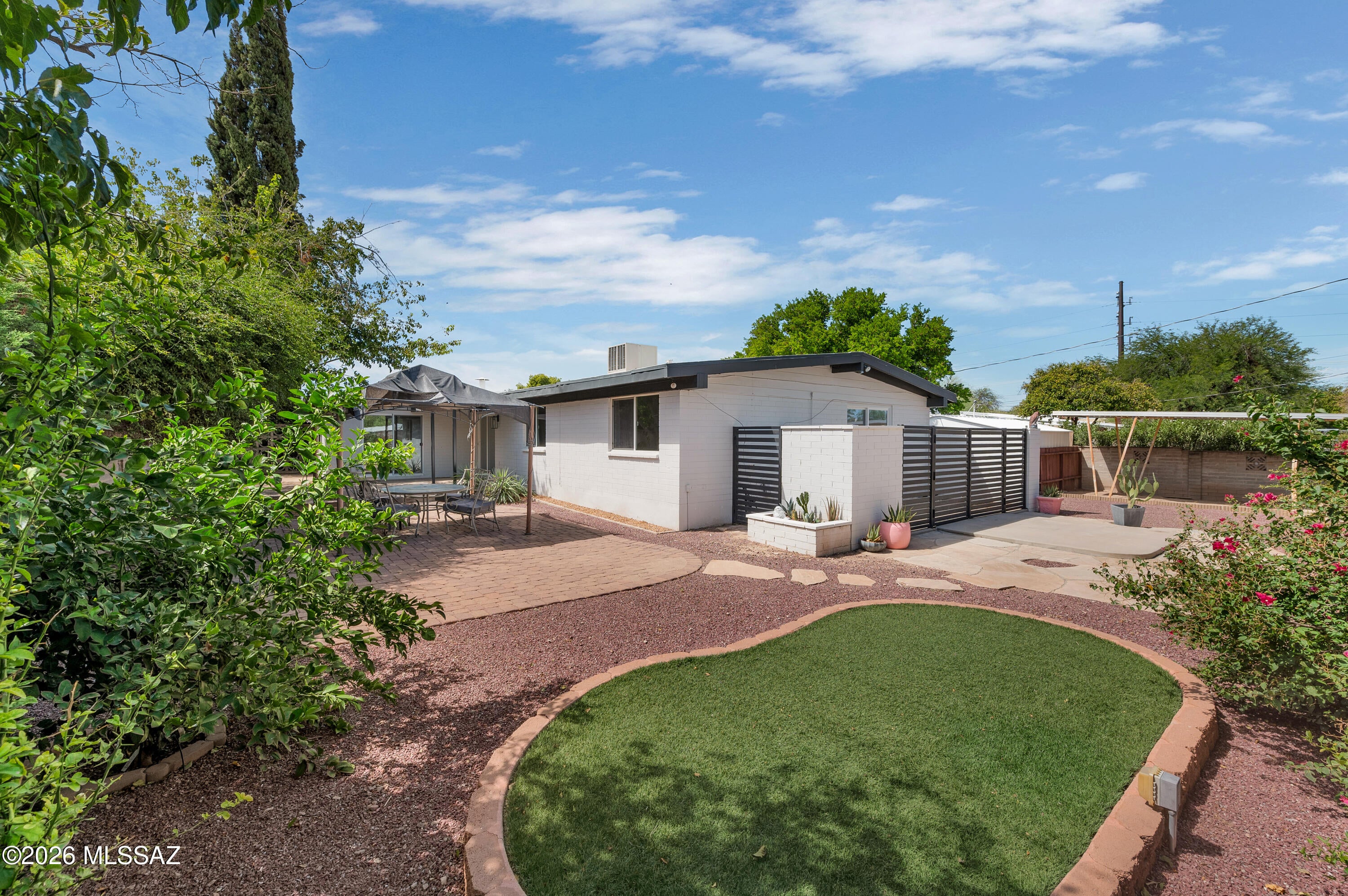 Welcome to 5521 E Kelso Street -- a beautifully updated Central Tucson home offering comfort, versatility, and an inviting connection to the outdoors. This spacious 4-bedroom, 2-bath home offers approximately 1,905 square feet of thoughtfully updated living space, with a consistent flooring design throughout that creates a seamless flow from room to room. The updated kitchen features modern cabinetry, granite countertops, a center island, and updated stainless-steel appliances, making it both stylish and functional. The versatile third bedroom offers flexibility to suit your lifestyle and could easily serve as a home office, den, hobby room, or additional living space. Outside, the property truly shines with a large, private backyard that feels both quaint and inviting--perfect for relaxing, entertaining, gardening, or simply enjoying Tucson's beautiful outdoor lifestyle. A welcoming courtyard adds another charming outdoor space, while the circular driveway and sliding vehicle gate provide convenient access and additional parking options. Ideally located near Tucson Medical Center, Pima Medical Institute, Fort Lowell Park, shopping, dining, and the many amenities Central Tucson has to offer, this home combines an updated interior with the outdoor space and flexibility today's buyers are looking for. A wonderful opportunity for anyone wanting a move-in-ready home in a convenient Central Tucson location.