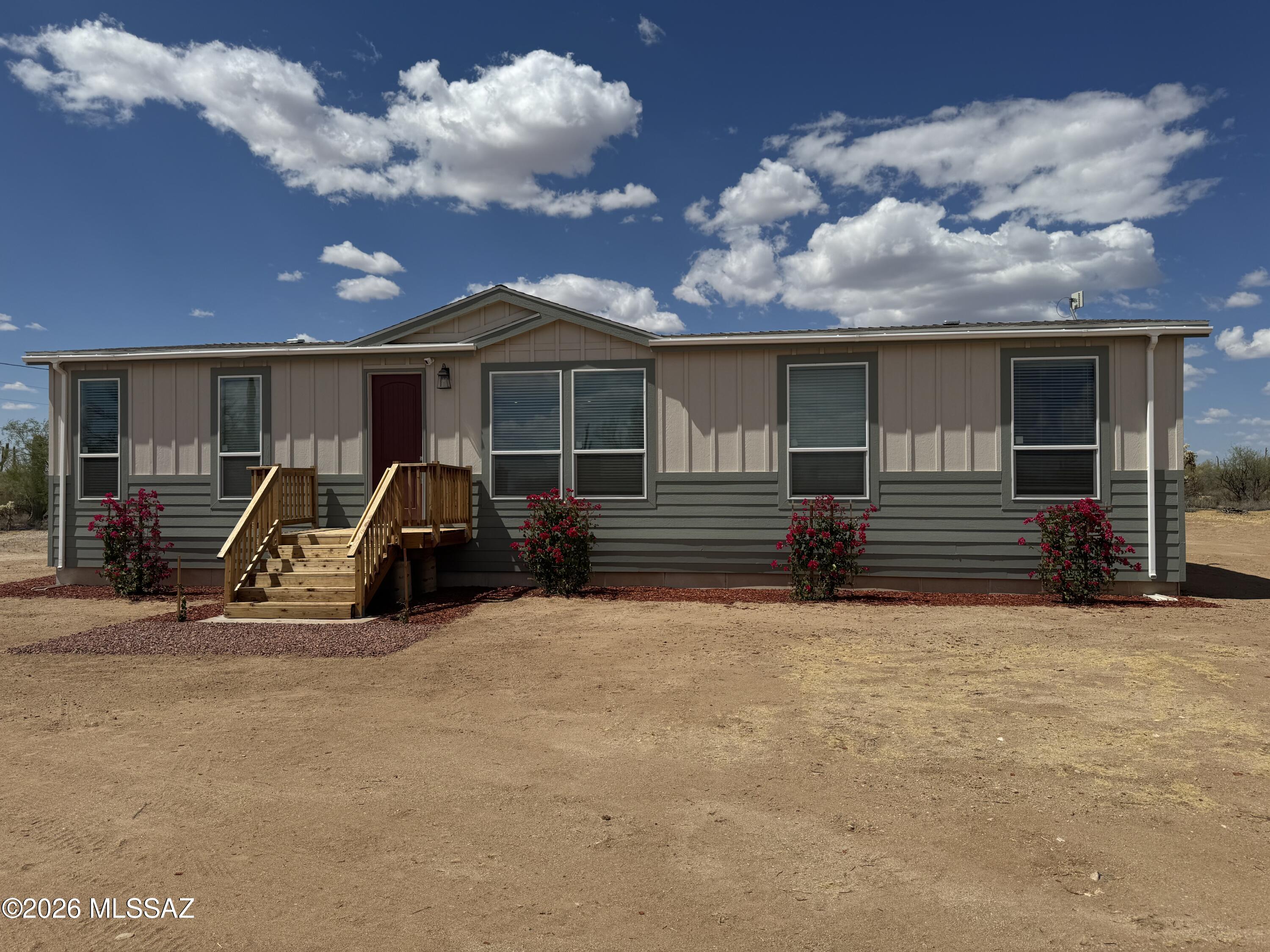 Experience modern desert living at its finest in this brand-new 2025 CAVCO top-of-the-line manufactured home, offering just over 1,800 sq ft of beautifully designed space on more than an acre of peaceful, natural desert landscape. Surrounded by saguaro, wide-open vistas, and striking mountain backdrops, this home captures the essence of Arizona tranquility--where sunrise and sunset views are truly extraordinary. Step inside to soaring 9-foot ceilings, oversized windows, and an open, light-filled floor plan that blends comfort with contemporary style. The upgraded interior features knotty alder cabinetry, a full tile backsplash, and stainless-steel appliances, creating a warm and upscale kitchen environment perfect for everyday living or entertaining.
Quality construction shines... throughout, with 2x6 exterior walls, 2x8 floor joists, and energy-efficient design supported by a powerful 5-ton heat pump.
Enjoy quiet evenings on the oversized deck, take in the sweeping desert views, and savor the privacy and serenity that come with a property of this size.
If you're looking for space, quality, and unmatched desert beauty, this exceptional 2025 CAVCO home delivers it all. A rare opportunity to own a brand-new, high-end residence in a secluded, picturesque setting.