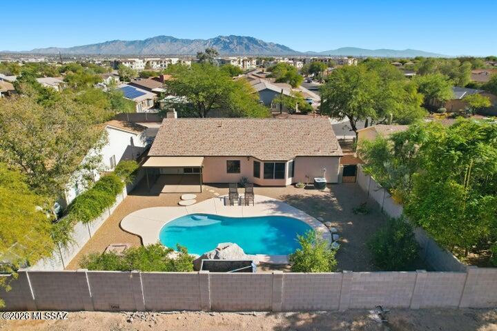 SUMMER IS HERE make the most of it in Marana's lowest-priced home with a pool and stunning mountain views. This 3-bedroom, 2-bath home offers comfort and potential with a cozy gas fireplace, beautiful plank wood flooring throughout (no carpet), and a spacious 2-car garage. Step outside to a private backyard with no neighbors behind you and breathtaking mountain views right outside your door. Major updates are already taken care of with a NEW roof and HVAC system, plus no poly pipes for added peace of mind. Enjoy a neighborhood park with a playground and sports courts just one block away. While the home offers an opportunity for cosmetic updates, that means you get the chance to create your own style and design choices rather than paying for someone else's taste.