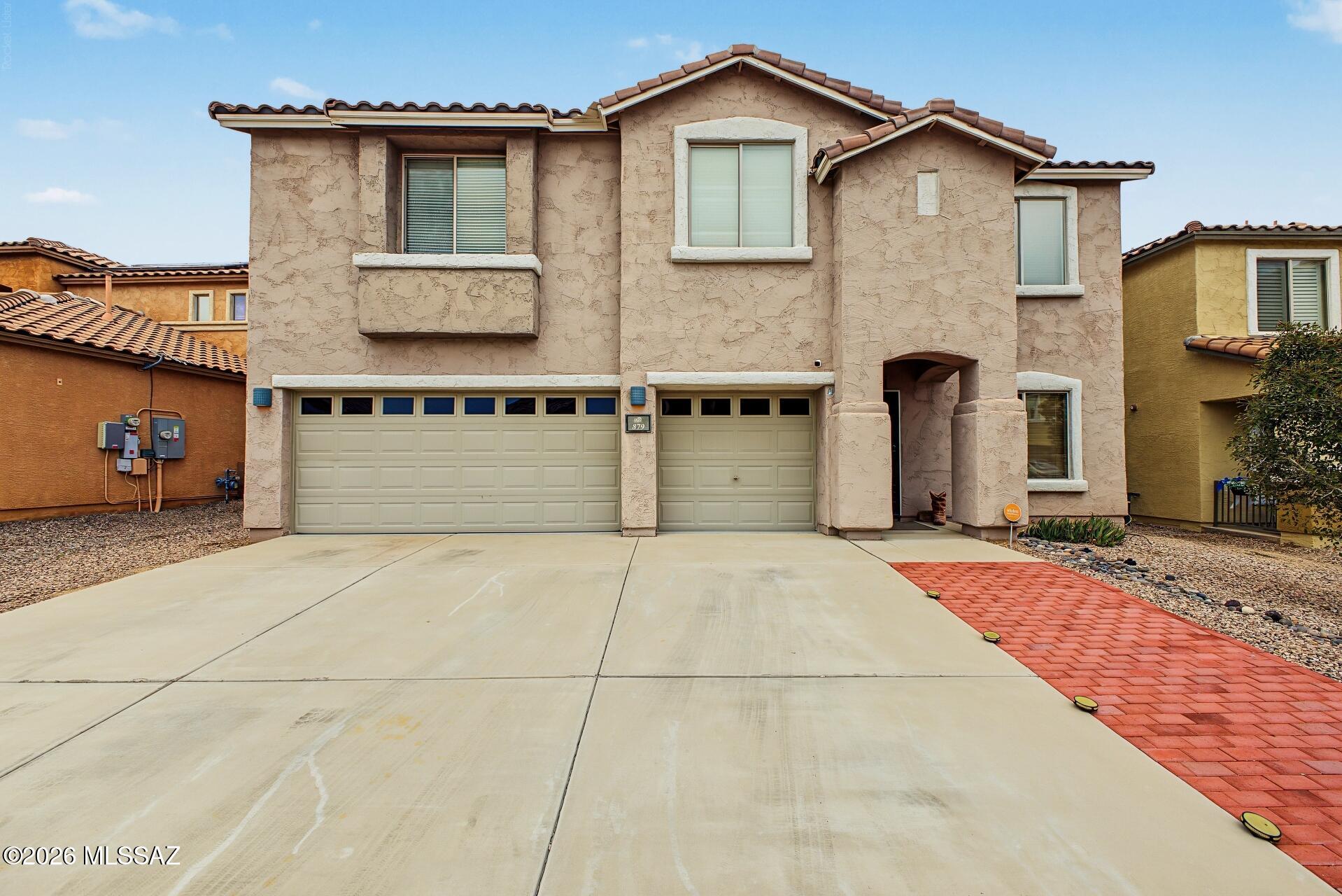 Fantastic two-story home in Rancho Sahuarita featuring 3 bedrooms, 2.5 baths, a versatile loft, and a 3-car garage with extended driveway. The open great room flows into a spacious kitchen with stainless steel appliances, granite countertops, pantry, ample cabinetry, and a large island with breakfast bar. Tile flooring downstairs and abundant natural light add to the inviting feel. Upstairs, the primary suite offers dual sinks and a walk-in closet. Enjoy the spacious backyard with covered patio, lawn, mature trees, and multiple seating areas. HVAC replaced in 2025! Enjoy all the amenities Rancho Sahuarita has to offer!