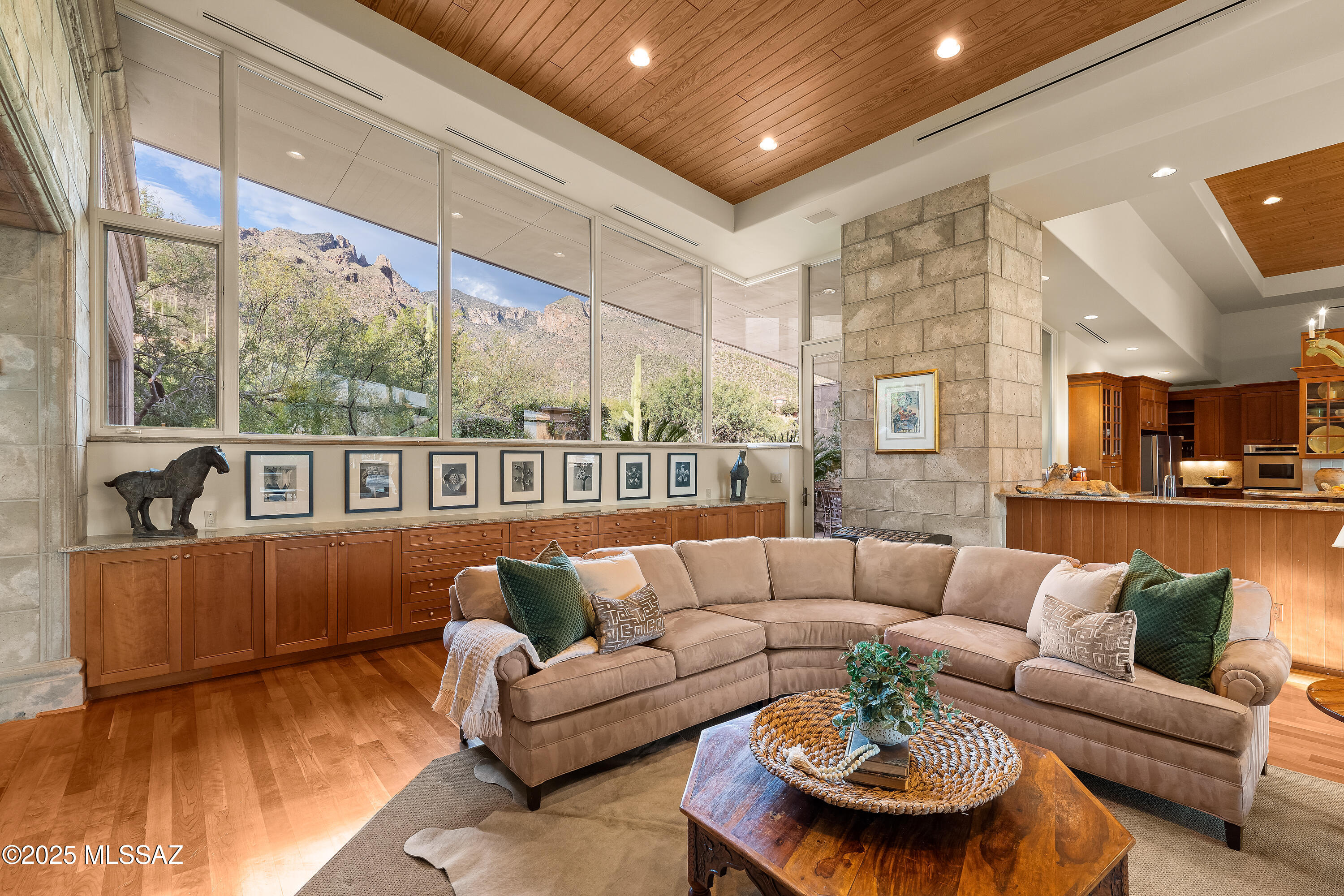 Designed by renowned architect Michael Franks, this extraordinary single owner custom built residence is one of a kind. From the dramatic walls of glass bringing the lush exterior spaces indoors, to the richly layered materials of cherry wood and custom concrete which perfectly juxtapose the modern lines of this home against its unparalleled natural environment. With a sprawling split floor plan that offers formal and flexible spaces, every room exudes a refined blend of artistry and craftsmanship which make it warm and intimate. Set within an exclusive guard gated community with paver finished roads, this private home captures timeless elegance and exceptional design integrity. Elegant stone and cast concrete at the entry continue seamlessly to interior spaces complementing three dramatic fireplaces and two outdoor fireplaces that anchor the home's ambiance. Expansive glass windows frame sweeping city and mountain vistas, while tongue-and-groove vaulted ceilings, solid wood flooring, and custom cast concrete details create a sense of timeless architectural distinction. Eight-foot solid wood interior doors, bespoke built-ins, and custom bookcases further elevate the home's interior sophistication.

The chef's kitchen is a masterpiece of form and function, featuring cherry cabinetry, three sinks, dual ovens, and dual refrigeratorsideal for both everyday living and entertaining. Numerous other accouterments such as a warming drawer, beverage refrigerators, and a butler's pantry position this residence for the highest level of entertaining.

Private spaces in this home offer character and quality accommodations for both owner and guests. A split floor plan provides privacy from two well appointed bedrooms while the primary suite is positioned near a fourth bedroom perfect for use as an additional bedroom, media room, or home fitness center. Unquestionably positioned at the most perfect location on this grand parcel though is the primary suite. Through a private den you enter this breathtaking space to a view of our stunning Tucson skyline and the mountains beyond. Two walk-in closets accompany the gracious bathroom with refined finishes and copious storage. A walk-in steam shower, garden tub, private water closet, and dual vanities complete this retreat.
The four car garage features extensive built-in cabinetry and additional storage space for convenience. The new standing-seam metal roof completes this architectural nonpareil  an exceptional expression of design, quality, and Tucson's natural beauty.