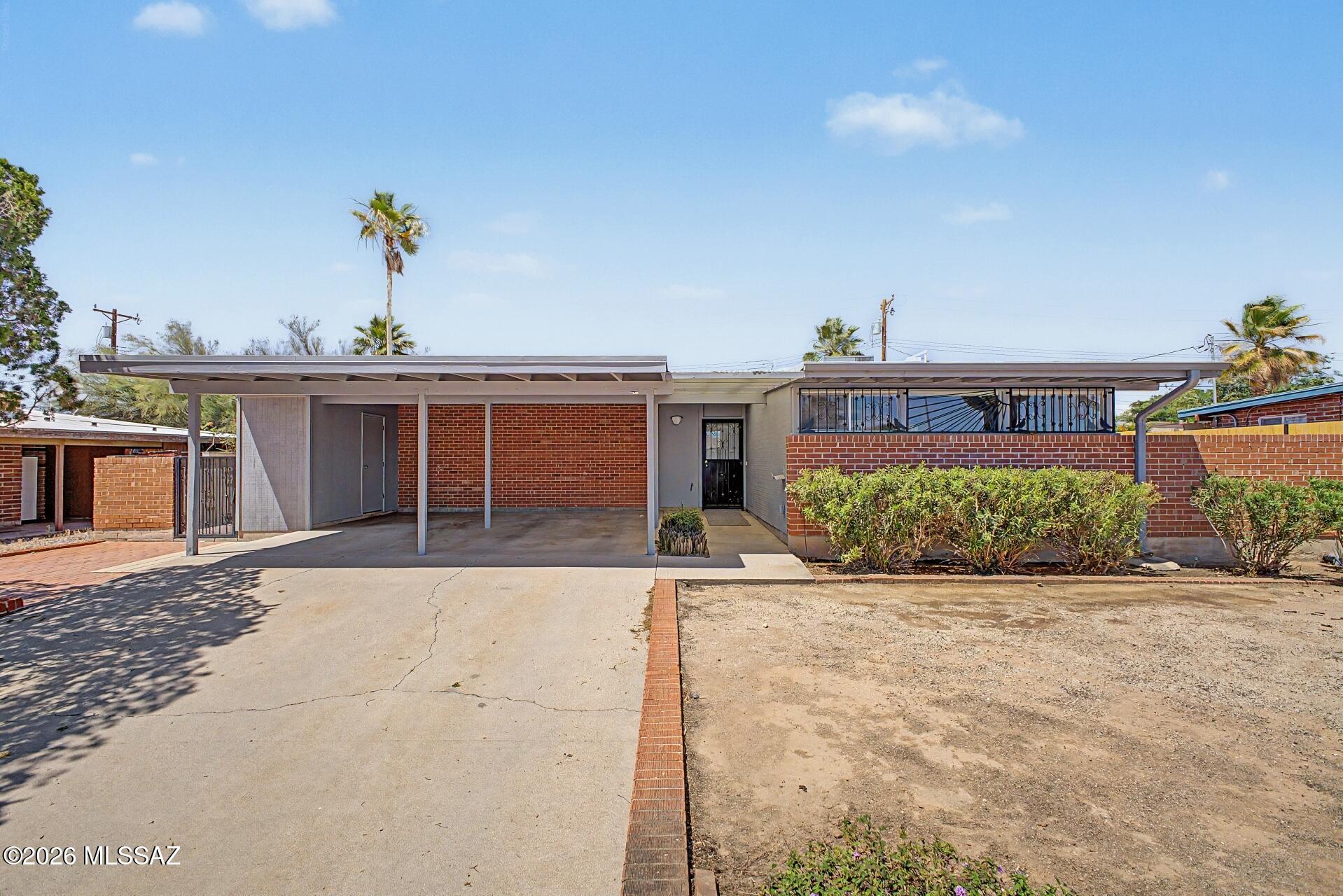 Fall in love with this charming single-story home! This gem boasts a great curb appeal, w/ a mature landscape and convenient carport parking. The interior showcases sizable living spaces designed w/ comfort in mind, featuring upgraded carpet, tile in select areas, & a soothing palette that makes every space feel warm and welcoming. Prepare feasts and quick meals in the bright galley kitchen, complete w/ oak cabinets adorned w/ crown molding, spacious counters, & essential appliances. The primary bedroom is a true retreat, including a private bathroom for extra comfort & easy outdoor access for convenience. Out back, your oasis awaits, w/ ample seating space, well-laid pavers, a ramada, perfect for gatherings, & a sparkling pool to enjoy sunny days! You don't want to miss it! Agent/Owner