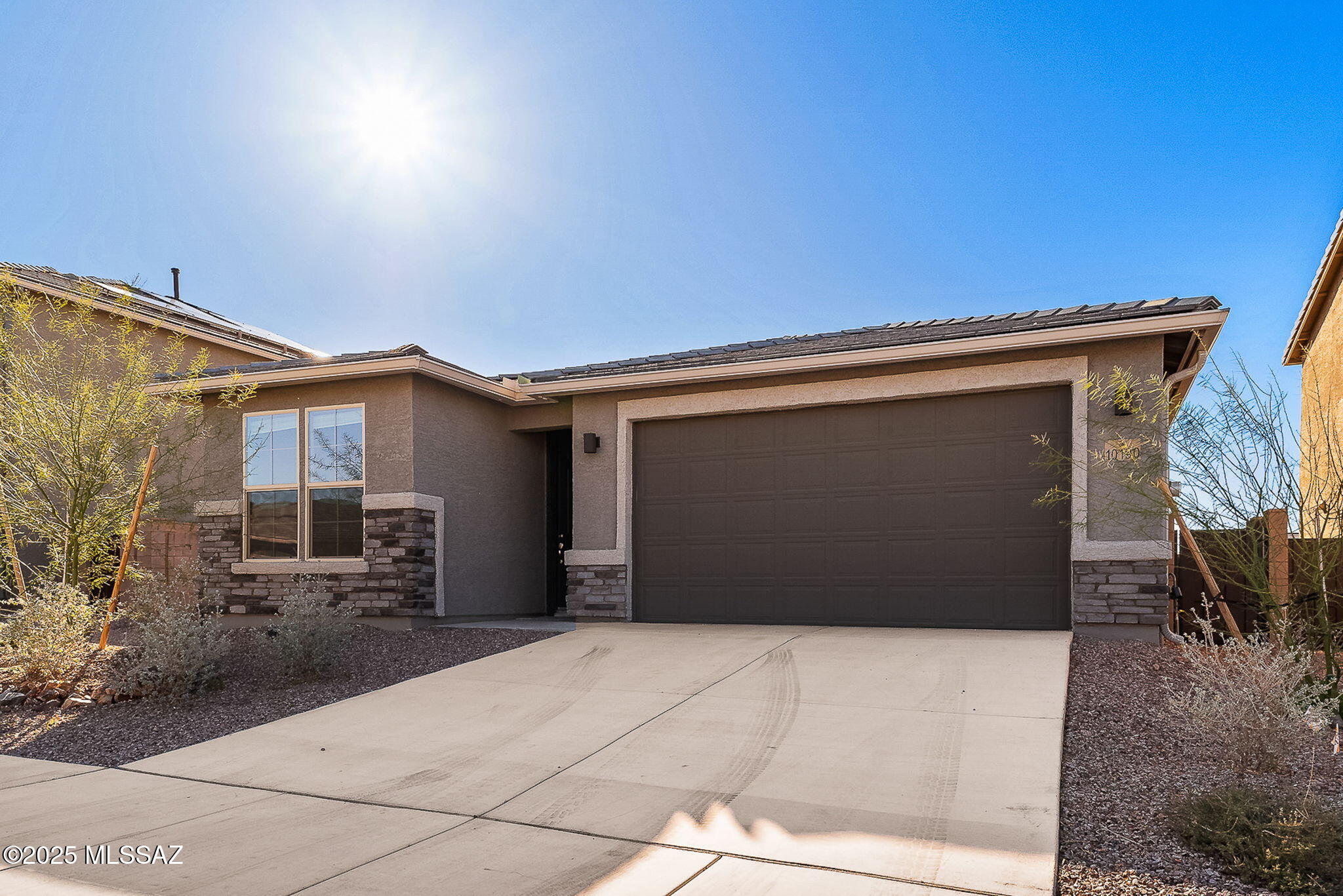 Why wait for new construction when you can move right into this beautifully maintained, like-new home in Rancho Del Lago & the award-winning Vail School District? Featuring 4 bedrooms, 2 bathrooms, and a versatile den, the thoughtfully designed split-bedroom floor plan provides both privacy & flexibility. The open-concept living space is filled with natural light & highlighted by wood-look tile flooring. At the heart of the home, the gourmet kitchen showcases quartz countertops, SS appliances, a large center island, & ample cabinet space. The spacious primary suite serves as a peaceful retreat, while the additional bedrooms and den offer flexibility for a home office, playroom, fitness room, or guest space. Step outside to a large backyard w/ low-maintenance landscaping & peekaboo mountain views, offering plenty of room to create the outdoor oasis you've been dreaming of. This home is just minutes from parks, golf, shopping, dining, and everyday conveniences. Modern, move-in ready, and full of potential!