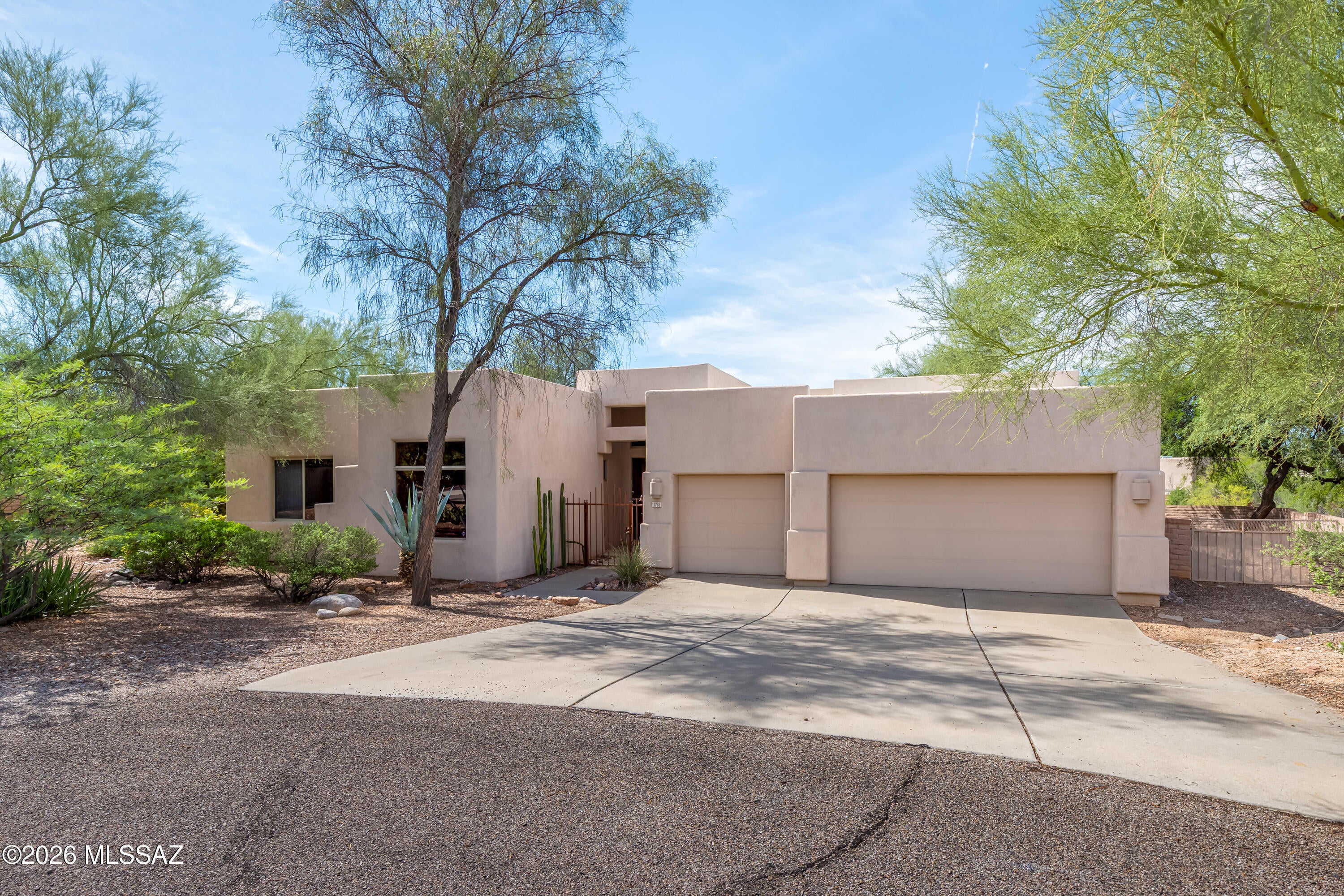 Spacious 4-bedroom, 3-bath home with a den, 3-car garage, and inviting desert setting in northwest Tucson. The flexible floor plan offers generous living spaces, a family room with fireplace, large windows, Saltillo-style tile, and a dedicated den/office with extensive built-in cabinetry and work space. The kitchen opens to the casual dining and family room and features abundant cabinetry and stainless appliances. The primary suite includes patio access, dual sinks, separate shower and soaking tub. Enjoy the private backyard with mature desert landscaping, covered patio, pergola and pool. Conveniently located near Northwest Medical Center with easy access to shopping, dining and services along Oracle Road.