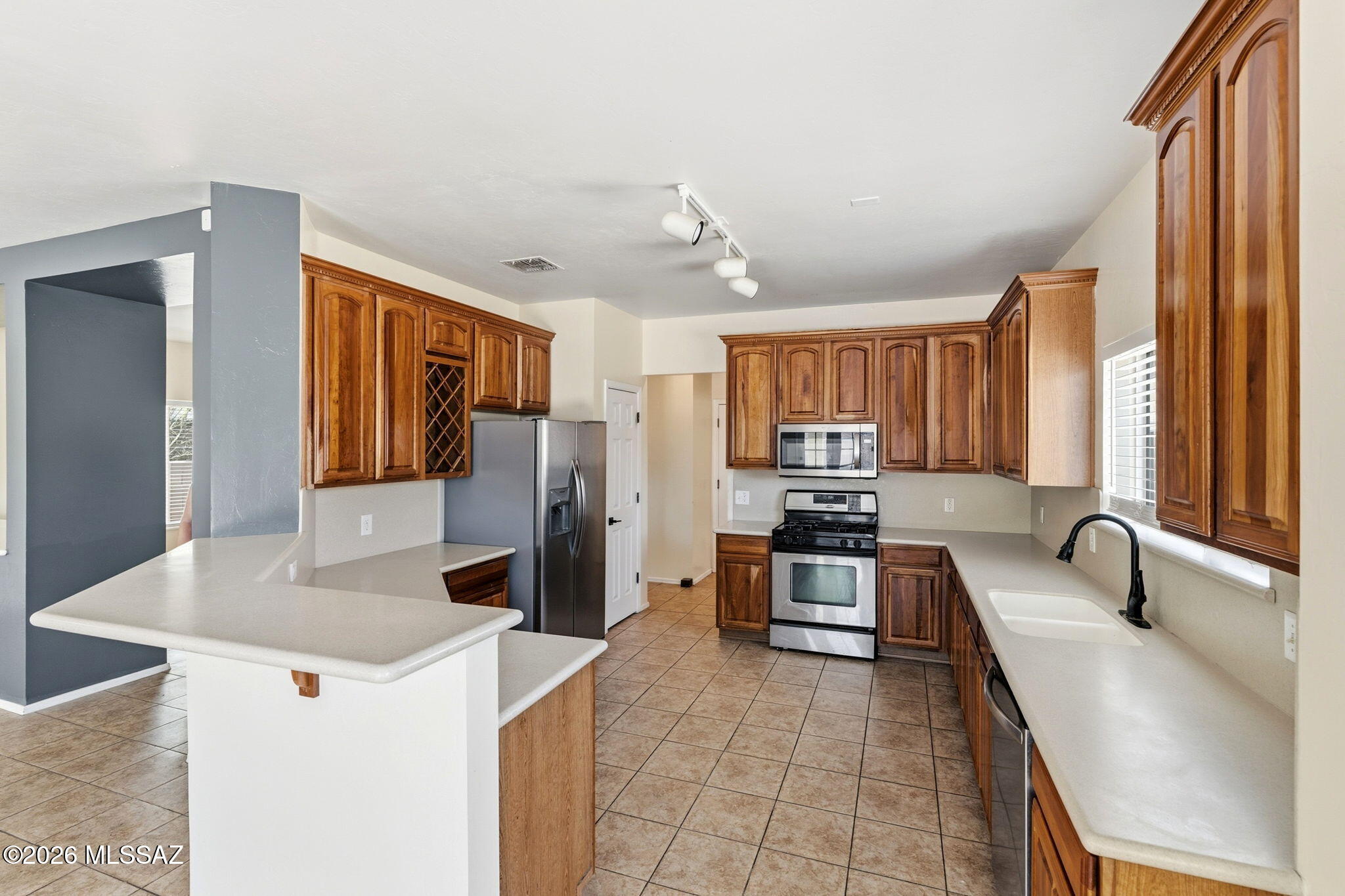 VA Assumable Loan Available at 3.625%! Upgraded 3-bedroom, 2.5-bath home with approximately 2,250 sq. ft. located in the desirable Santo Tomas Villas community in Sahuarita. Enjoy low HOA fees of just $24 per month and a thoughtfully upgraded interior designed for comfort and convenience. 

The spacious kitchen features upgraded cabinetry, stainless steel appliances, Corian countertops, backsplash, and a built-in wine bottle holder. Ceramic tile flooring runs throughout the entire first floor, while brand-new carpet extends up the staircase and throughout the second level. Additional interior highlights include ceiling fans, faux wood blinds, updated door hardware, smart thermostat, and dual sinks in both the primary and hall bathrooms. Upstairs, a large loft provides flexible space for a home office, media room, playroom, or additional living area. The refrigerator, washer, and dryer are all included, making this home move-in ready. 

Outside, you'll find a 3-car garage with 8-foot doors, a newer MyQ garage door opener, freshly painted garage flooring, and a soft water loop already installed. The backyard is ideal for relaxing or entertaining, featuring an extended covered patio, additional paver patio space, and a storage shed. Enjoy beautiful mountain views from the primary bedroom window. 

This home offers an exceptional combination of space, upgrades, and value--plus the rare opportunity to assume a VA loan at an attractive 3.625% interest rate.