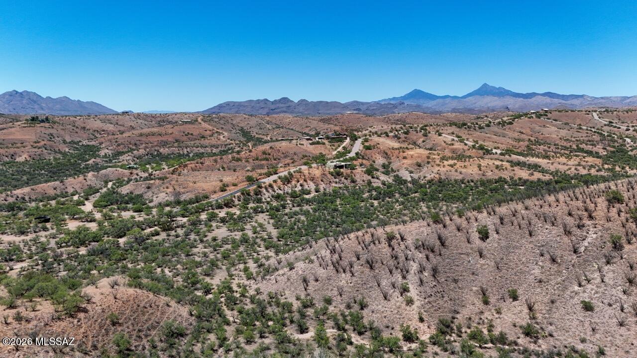 This breathtaking 40+ acre parcel stands out for its exceptional 360° mountain views, gorgeous high desert habitat, and delicious serenity. While very near Lake Patagonia and all its amenities, and conveniently located between the historic Patagonia and Nogales, it offers an ideal rural setting in every way. This is your chance to own land at a great price at Patagonia Lake. This won't last long at this price. Most likely, the two best building sites are at the top of the ridge. The dramatic nature of this parcel is perfect for building an exceptional home. The HOA is excellent, and Patagonia's schools are available to you, along with other districts including Nogales and Rio Rico.