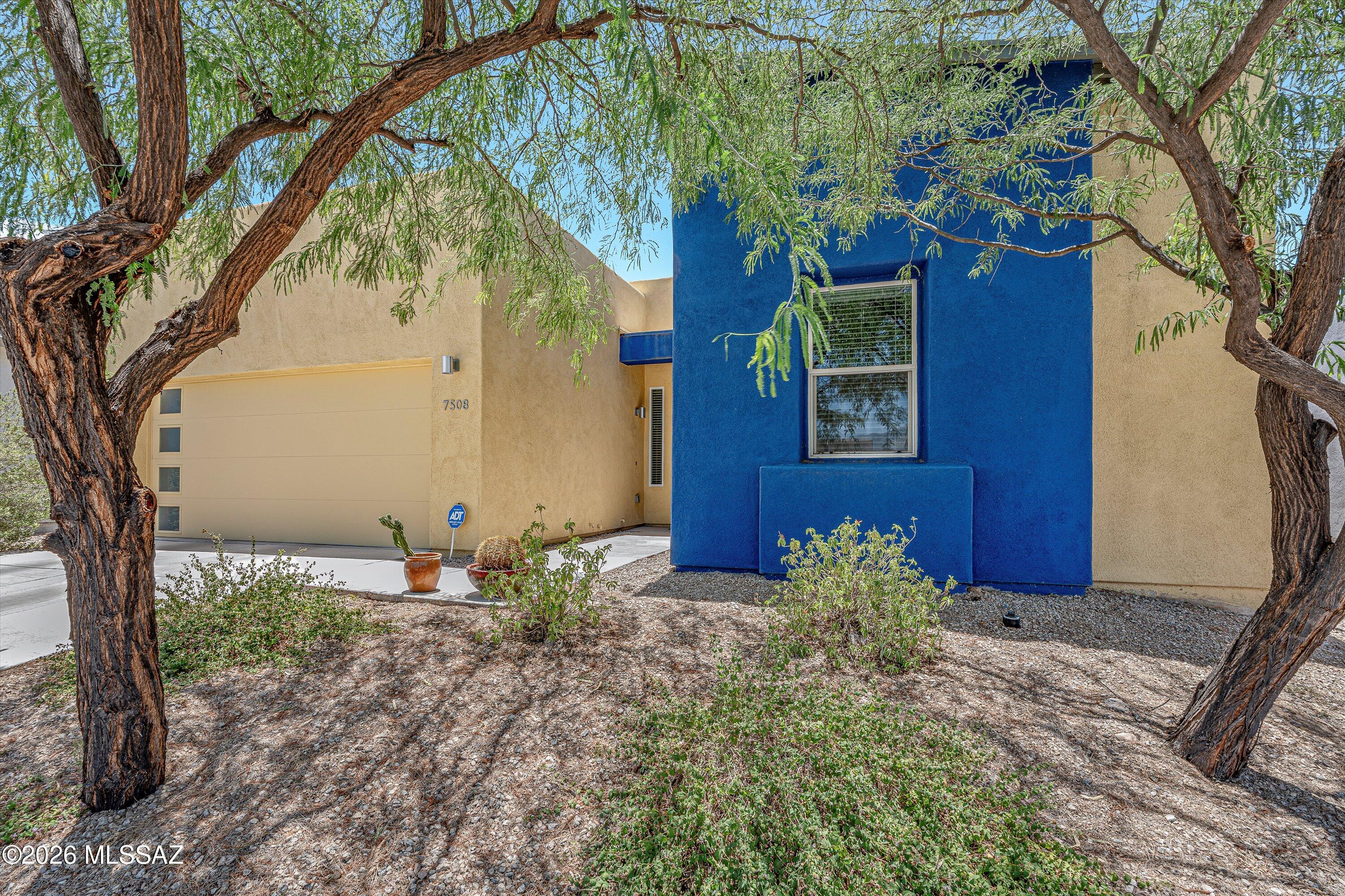 Welcome home to Elementary Place! Pepper Viner Quality Mid Century Modern architecture with thoughtfully designed living space & modern finishes throughout. The open-concept kitchen shines with Piedrafina Marble countertops, stainless steel appliances, gas range, a tile backsplash, and a large peninsula -- perfect for entertaining. The great room features built-in shelving, tile floors, and a slider opening to a covered patio and private walled backyard. The primary suite includes carpet, recessed lighting, a dual-sink vanity, walk-in shower, and walk-in closet. Smart Home Features, including NEST thermostat and smart entry lock. Extended 2-car garage, and low-maintenance desert landscaping. Minutes to Udall Park, shopping, and dining. This one truly has it all!