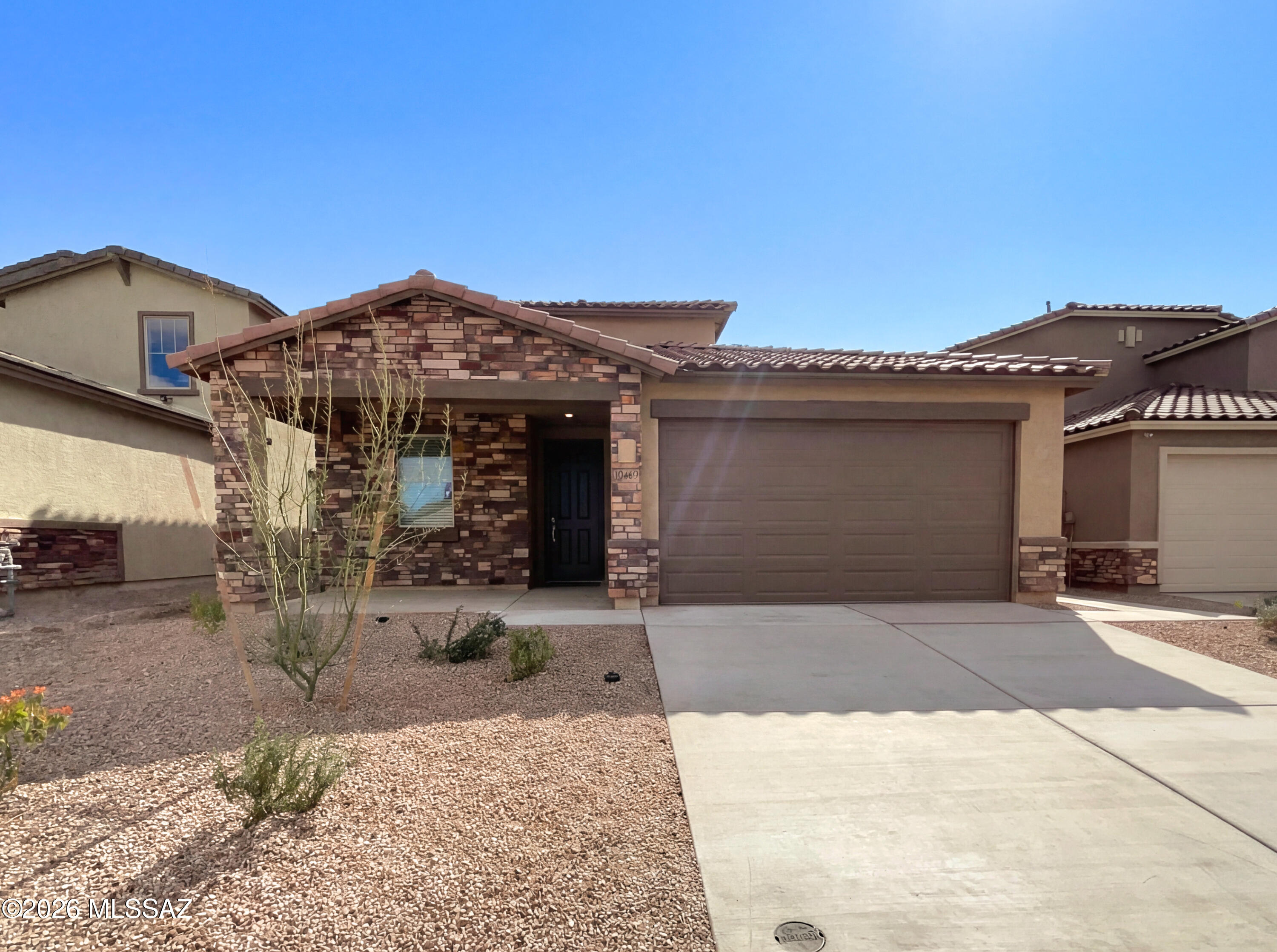 Welcome to this spacious 4 bedroom, 3.5 bath home with a 3-car tandem garage in the vibrant Gladden Farms community in Marana - perfectly designed for flexible lifestyles and multigenerational living. A dedicated NextGen suite exceptional  with its own entrance, living room, kitchenette, bedroom, bathroom, and laundry making it ideal for extended workspace. Enjoy an open floor plan filled with natural light, a well-appointed kitchen with granite countertops, stainless steel appliances. A versatile flex space provides the perfect spot for an office, playroom, or hobby area. Upstairs, a loft adds even more room to relax, along with three additional bedrooms and a second laundry room. Enjoy the beauty of the Arizona desert with year-round outdoor recreation, sunsets, and towering saguaros.