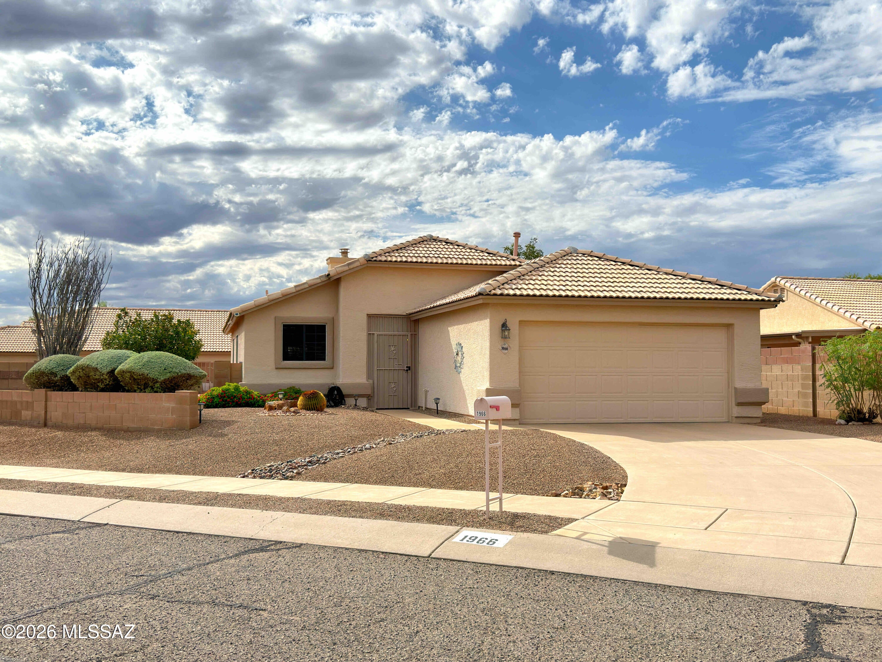 Meticulously maintained and spotless, this light-filled gem shines with pride of ownership! Vaulted ceilings, a new roof in 2021, and new HVAC and water heater in 2022 enhance its appeal. The updated kitchen features quartz countertops, updated sink and faucets, and replacement appliances, including dishwasher, range, refrigerator and microwave. Enjoy refreshed bathrooms and mahogany-look laminate flooring. The third bedroom was professionally converted to a den and can easily be converted back. Expansive back and side yards and a double covered patio with roll-up sun shades and awnings invite relaxing and entertaining. Desirable location near Northwest Hospital and shopping, with easy freeway access. Regularly scheduled maintenance adds to this home's exceptional care.  See More... Thoughtful improvements and attentive maintenance extend throughout this inviting home. The roof was replaced in 2021, including updated plywood, underlayment and tile battens, replacement of cracked or broken tiles, and three new skylights. The HVAC is serviced twice annually, and the water softener receives regular service. Gas hookups are available in the kitchen. Updated bathroom sinks and simulated marble shower walls, refreshed lighting and brushed nickel door hardware complement the interior. The finished garage offers two built-in storage areas, with the garage door spring replaced in 2025. Outside, the generous double patio features stucco ceilings and columns, brick paving and roll-up screens on three sides. A gas BBQ connection, wiring for a spa, and drip irrigation lines and timer installed in 2023 enhance the outdoor space. The patio roof received white sealer in 2026. A beautifully cared-for home with room to relax, entertain and make it your own! Rarely do you find a home so meticulously maintained, consistently serviced and lovingly cared for.