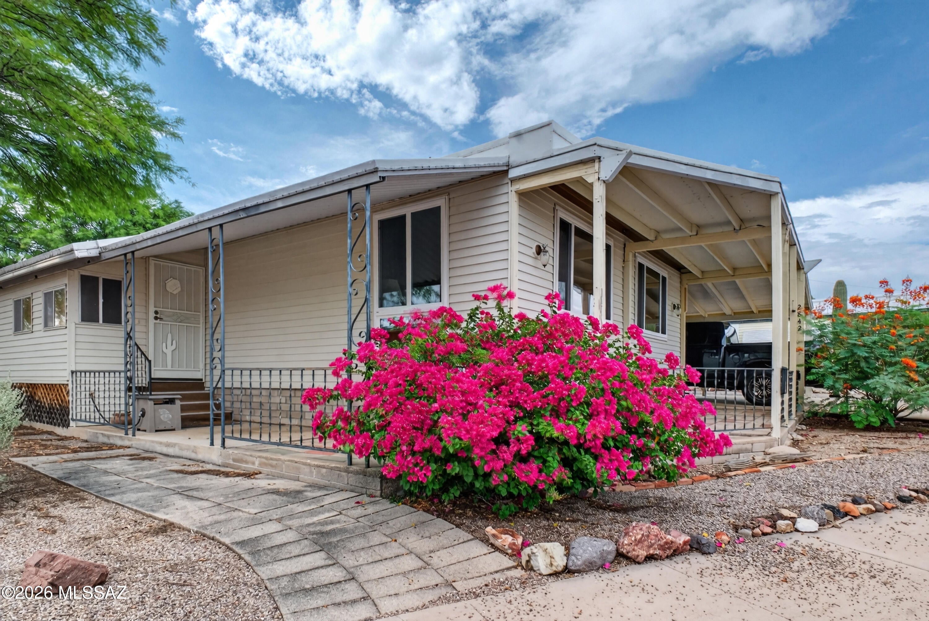 Welcome to 2842 S Western Way Cir, a fully updated 2-bed, 2-bath retreat in the active 55+ community of Tucson Estates. Offering 1,440 sq ft of dialed-in living space, all the heavy lifting is already done. We're talking a brand-new HVAC system (installed January 2024), fully updated PEX plumbing, and a roof that was freshly coated just two years ago. Inside, the kitchen and primary bath have both been tastefully updated, and the ceilings are fully taped and textured. You'll enjoy the extra space in the north-facing Arizona room, which connects to a seriously great workshop for your hobbies and projects. The laundry setup is fully equipped with a utility sink and a second fridge.
Outside, you get solid mountain views--and the best part is, you own the land. The community hooks you up with unlimited golf, tennis, pickleball, pools, a spa, and a fitness center.