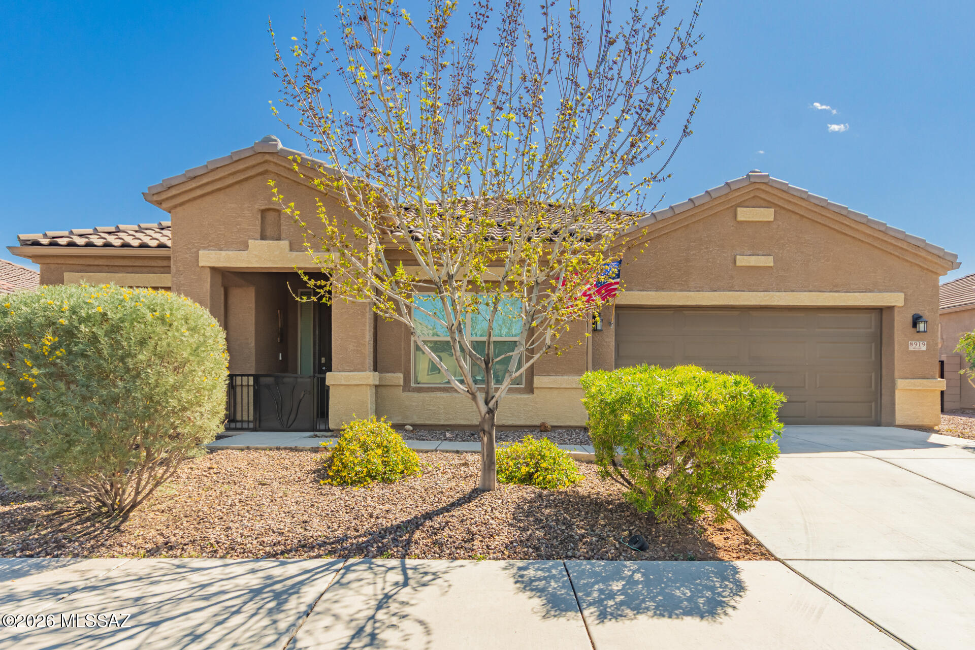 Welcome to the gated Saguaro Bloom 55+ community! This beautifully maintained home offers 3 bedrooms plus a flexible office/den with French doors, 2.5 baths, and an open-concept layout perfect for everyday living and entertaining. The kitchen features granite countertops, upgraded cabinetry with crown molding, a professional-style range, and pendant lighting. High ceilings, tile flooring, and neutral tones create a bright, inviting feel throughout. New paint throughout the home. Enjoy indoor-outdoor living with backyard access and an extra-wide driveway for added convenience. Community amenities include clubhouse, fitness center, and two pools. The home includes a tankless water heater and a whole-home water softener system, offering added comfort, efficiency, and convenience.