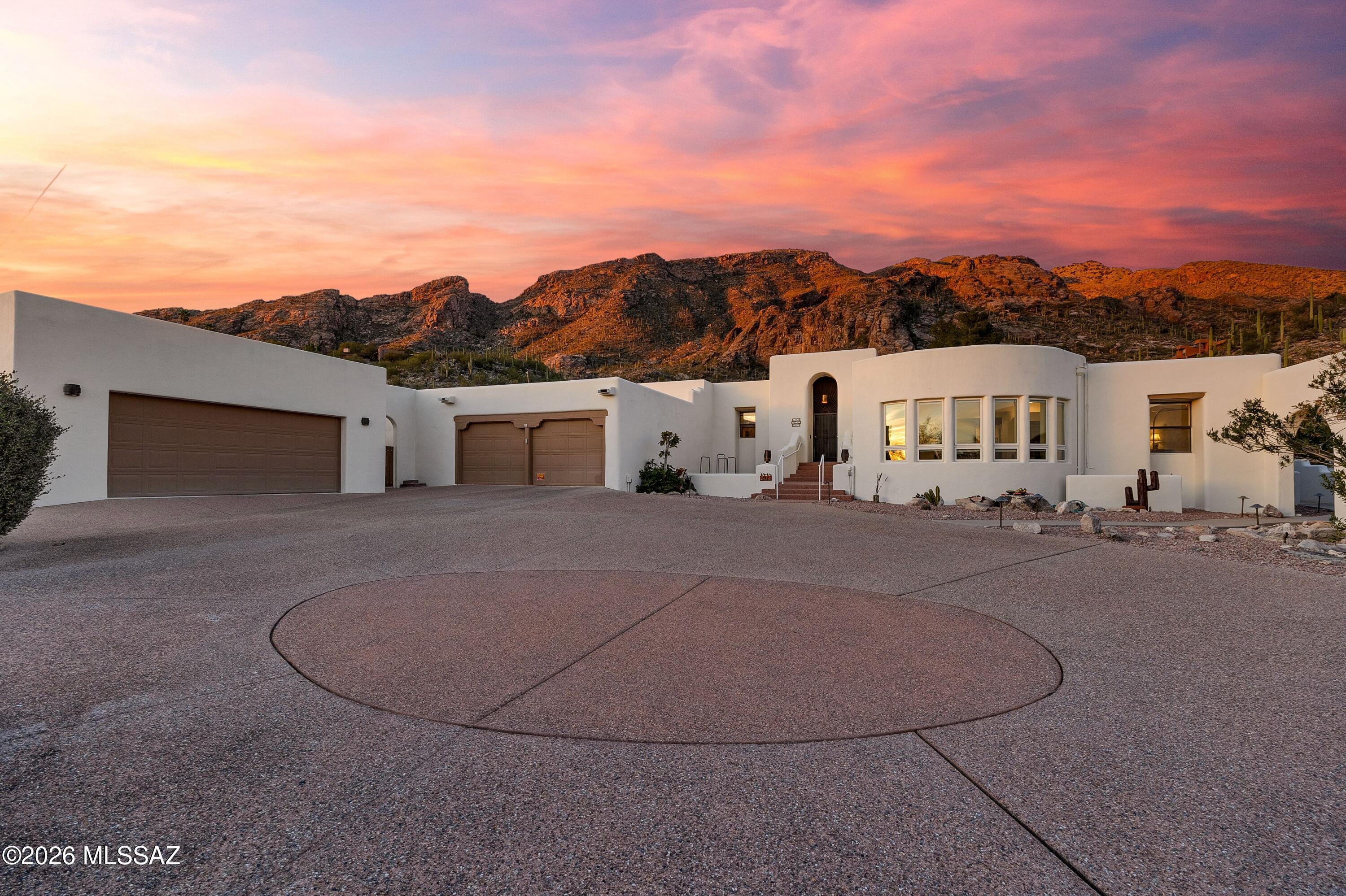 This fabulous Skyline Country Club home with a casita on the most northern section of the neighborhood brims  with character and charm. The rustic wood floors, soaring wood beamed ceilings & kiva fireplaces are reminiscent of a rustic resort. The split floorplan affords much privacy to your spacious primary suite equipped with a  luxurious primary bathroom, a closet to die for & an attached private flex space with endless possibilities. Two sizable additional bedrooms in the main house  with separate bathrooms. The pool area is an unrivaled setting with stellar views & spectacular ambiance! Space behind the garage could be a gym or workshop. BONUS detached casita has a full bathroom and is perfect for visiting family, or home office. AND the most picturesque desert and city views! Arizona room to protect your cactus garden.  4 car garage.