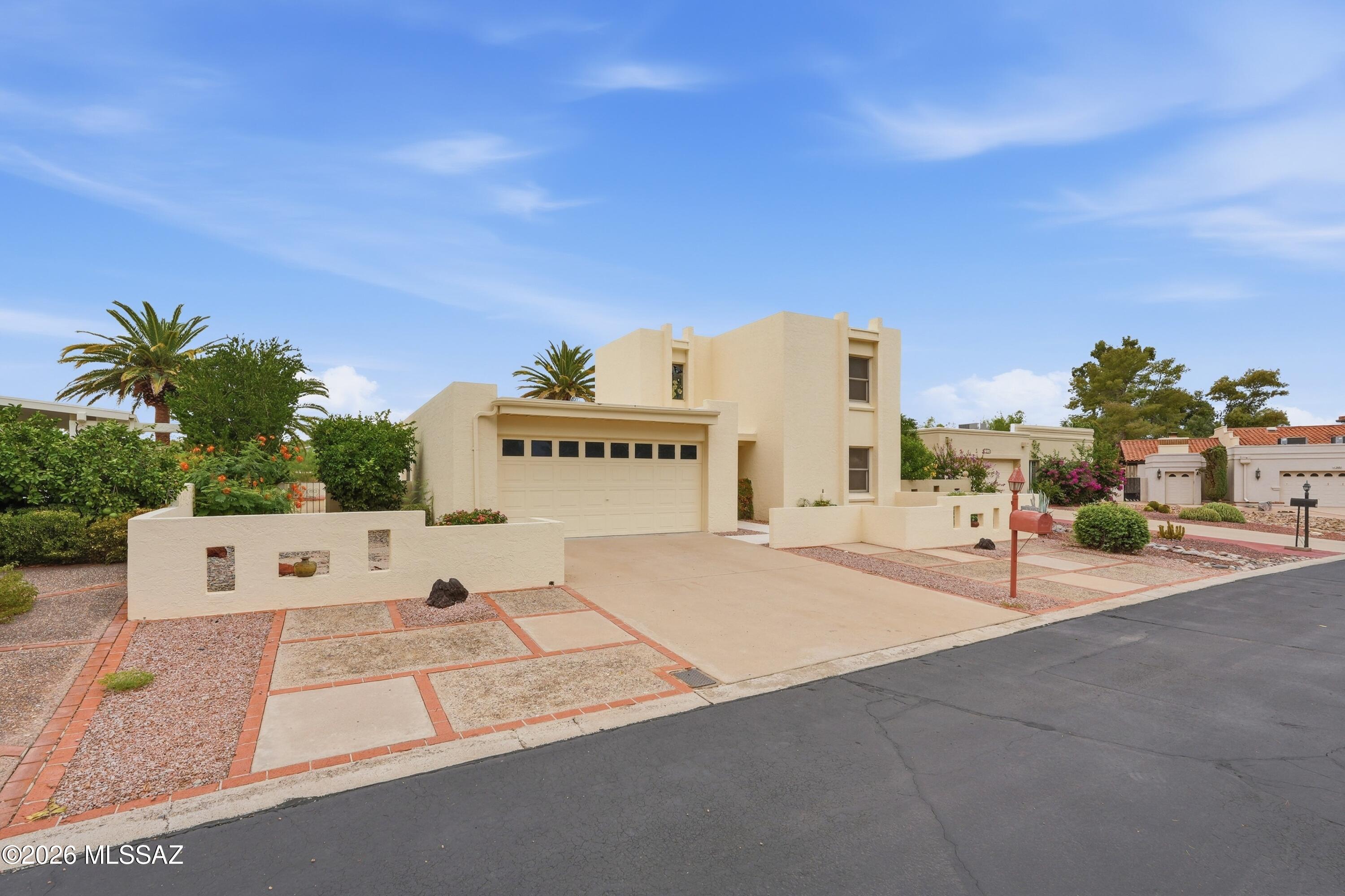 Welcome Home located in a gated 55+ community at Tucson National Omni Resort & Spa. This freshly renovated home combines comfort, privacy, security, and relaxed Southern Arizona lifestyle.  Step inside to find new tile flooring throughout the first floor, creating a fresh, updated look with easy maintenance. Main floor offers 2 bedrooms including primary suite and 2 bathrooms.  The second floor is perfect for either guest or live in help.  Come live and enjoy the resort style atmosphere Tucson National has to offer.  Enjoy exceptional backyard privacy with no neighbors directly behind the property perfect for relaxing and enjoying Tucson's beautiful weather.