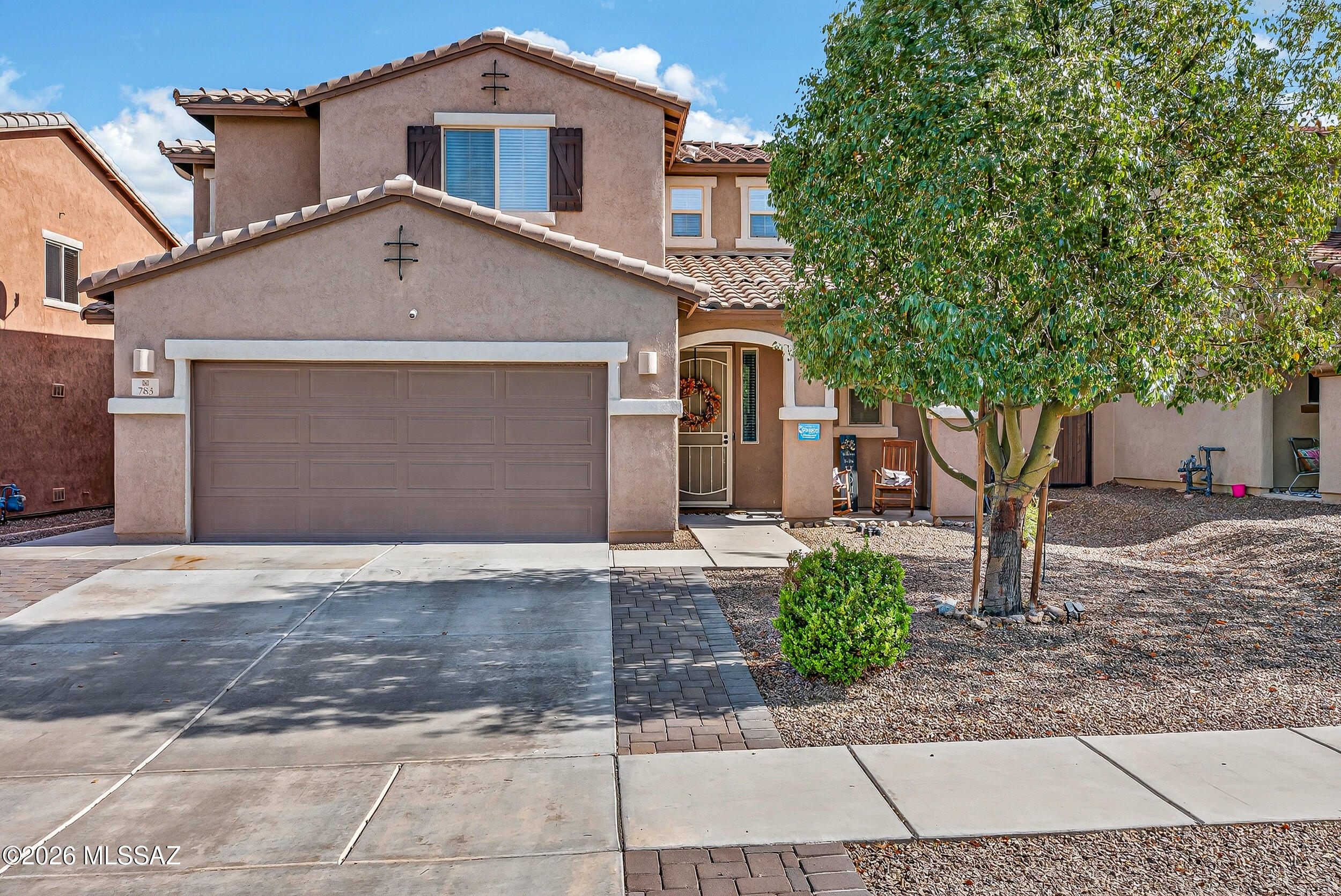 Rare Find: this two-story residence with in-law suite offers a comfortable open layout designed for everyday living and entertaining. The main living area flows seamlessly into a spacious dining area and kitchen featuring extensive cabinetry, granite countertops, stainless steel appliances, a gas range, and a center island with additional prep space. Large windows and a sliding glass door bring natural light into the living room and provide easy access to the backyard. Wood-style flooring adds warmth throughout the main level. Bonus living suite has own front entrance, bedroom, living area and bathroom. The home's exterior includes a welcoming covered front porch and a two-car garage with a wide driveway. Located in Sahuarita, the property is within convenient reach of shopping, dining, parks, and local community amenities, offering both comfort and accessibility in southern Arizona living.