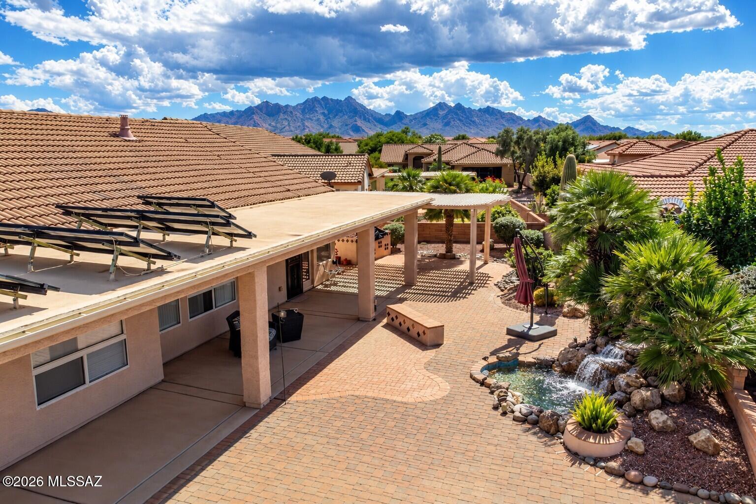 Your Quail Creek dream awaits in this desirable Ponderosa model, nestled within an exclusive 55+ gated golf community! This 2-bedroom, 2-bath home features fresh interior paint, an open den concept, and tile floors throughout except in the bedrooms. The spacious kitchen offers a large island and abundant cabinet space, opening to a family room warmed by a see-through fireplace. A formal living room and dining room create an elegant space for entertaining. Retreat to the primary bedroom, spacious bathroom and its large closet with custom shelving. The outdoor space is an entertainer's paradise, featuring a large pie-shaped lot with room for a pool or hot tub, a beautiful pergola with built-in BBQ, fruit trees, and calming fountain. Enjoy comfort, versatility, and the Quail Creek lifestyle!