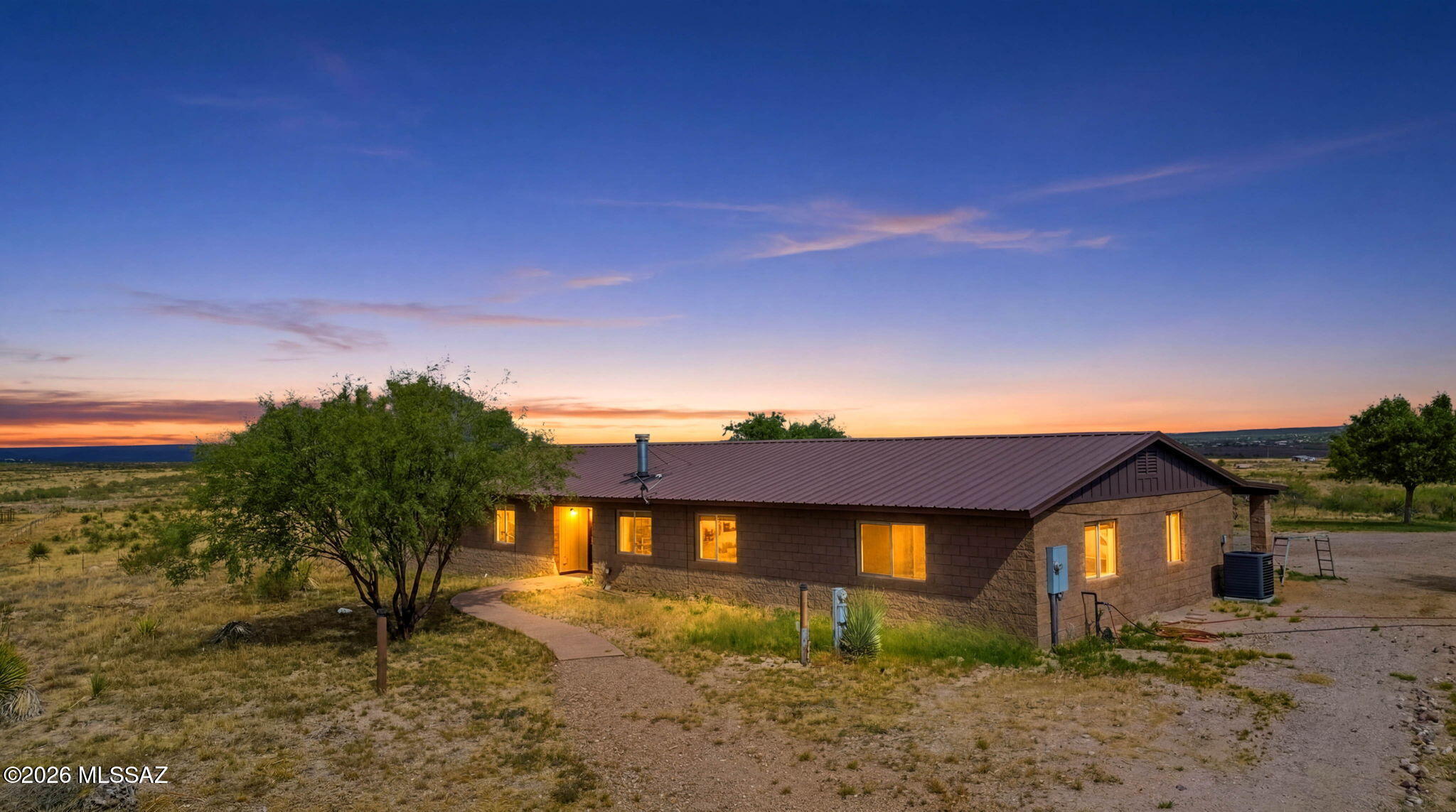 Escape to your own private slice of Arizona on 4.4 acres with panoramic mountain views, wide-open skies, and room for horses, RVs, and all your toys. This spacious 4-bedroom, 3-bath home features an open-concept layout, granite kitchen countertops, abundant cabinetry, and a large island perfect for gathering with family and friends. The split-bedroom floor plan offers a luxurious primary suite with a jetted soaking tub, walk-in shower, oversized closet, and private patio access. Outside, enjoy a private well, fully fenced acreage, barn, chicken coop, workshop, RV parking, and a detached 3-car garage. Surrounded by natural desert beauty and incredible sunrises and sunsets, this property delivers the privacy, freedom, and country lifestyle you've been dreaming of.