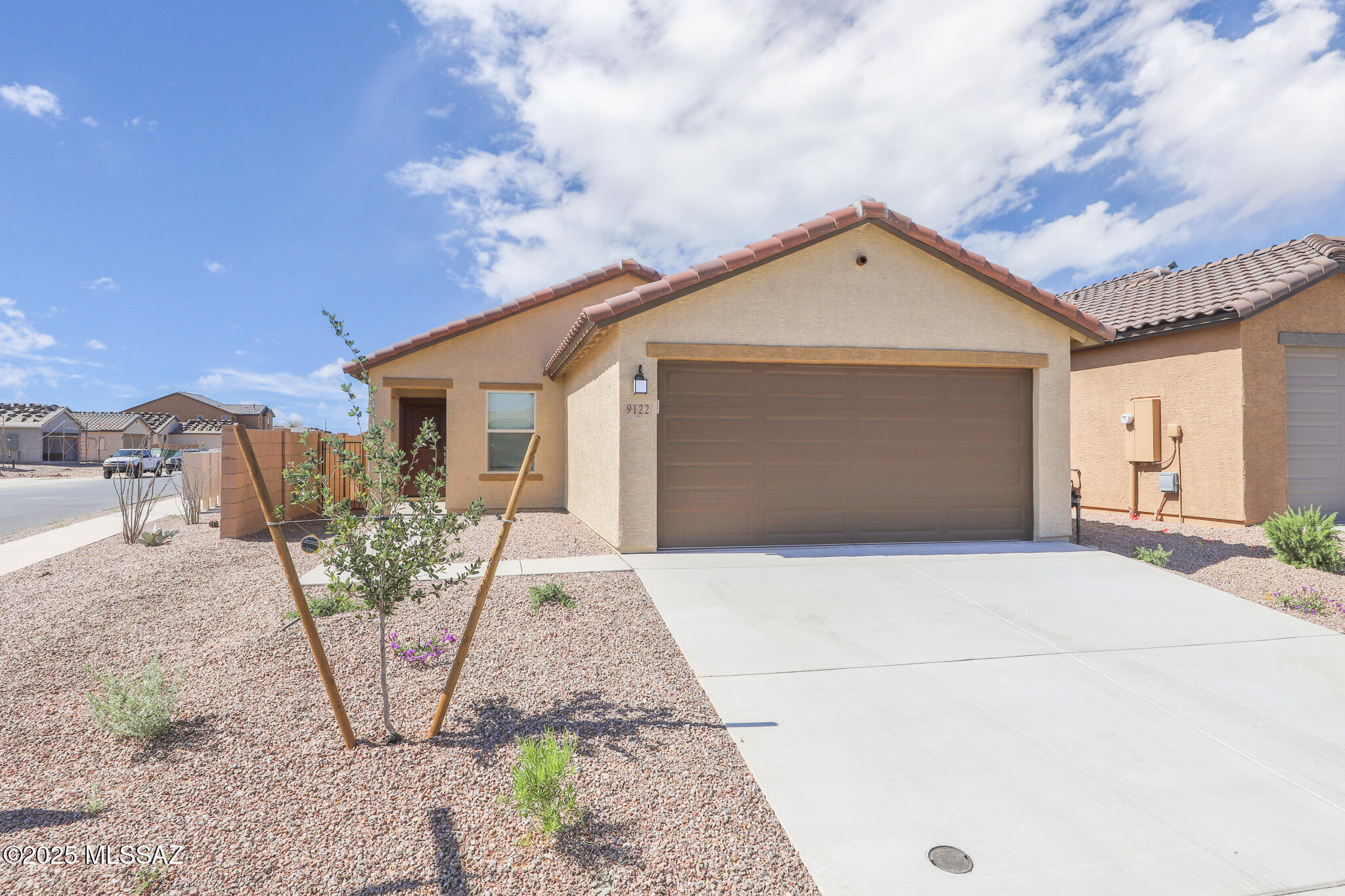 This new build features a split floorplan with porcelain wood plank flooring throughout. It comes with all appliances, including a washer/dryer and built-in microwave with air fryer. The open great room, large island, and beautifully landscaped backyard with mountain views, artificial turf, fruit trees, and extended paver patio make it ideal for entertaining. Additional amenities include walk-in closets, a spacious primary bedroom,  plus state of the art; electric car charging outlet, remote operation of thermostat & garage door. Convenient to DMAFB, parks, & Pima community college. *tenant occupied-48 hour notice required for showings. **type & quantity of pets require owner approval.