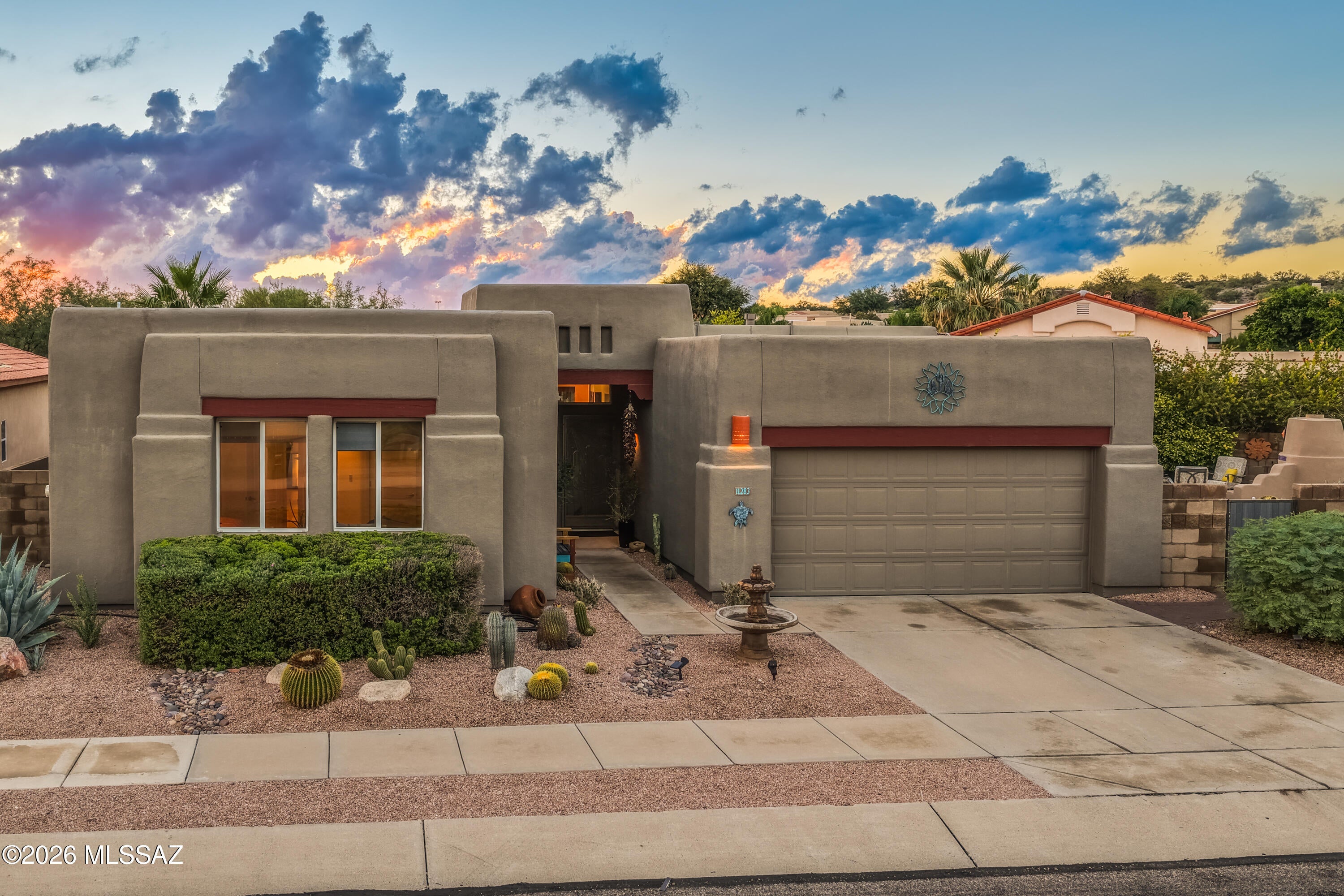 Exhale... You have finally found the one you've been looking for! This beautiful, well-maintained home located in the heart of Oro Valley has everything you need and is within walking distance to Naranja Park - Oro Valley's largest, state of the art park. The house is nestled on an elevated, premium lot with no direct neighbors from the backyard side. As soon as you arrive, the property will welcome you with impeccable curb appeal. Inside, classic Southwestern character blends seamlessly with tasteful modern upgrades. Walk in and prepare to be amazed exploring the immaculate interior with wooden beams at the entrance, new luxury vinyl plank flooring throughout, fresh coat of paint and abundance of natural light. Large living room - featuring wooden beams, gas fireplace and wall of windows overlooking the backyard and pool area - has lots of architectural charm that creates a warm, sophisticated atmosphere ideal for relaxation or family gatherings. Spacious kitchen boasts granite countertops, stylish backsplash, elegant large ceramic tile flooring, pantry, and top-of-the line stainless steel appliances, including a double oven range, newer dishwasher and brand-new refrigerator. Dining area is conveniently located right by the kitchen with pool view and patio entrance for outdoor dining. Exquisite primary suite has access to patio, walk-in closet and includes a spacious bathroom with separate shower, soaking tub and a dual-sink vanity. Two guest bedrooms at the front of the house feature mountain views and are serviced by a full bathroom down the hallway. Cozy den with front entry view is perfect for an office, but also large enough to serve as an additional bedroom. The laundry room is equipped with high-end front load washer and dryer that convey. Step outside and enjoy your private, quiet backyard oasis, relax in the sparkling pool (gas hookup for pool heater installed) or simply unwind in one of several sitting areas. Large, covered patio finished with Saltillo tiles and equipped with an awning is just a prelude to the picture perfect, professionally landscaped and manicured backyard. The outdoor living space was designed with low maintenance and owners' comfort in mind. Don't miss the "secret garden" in the side yard. You will love long evenings in a fireplace gathering area with beautiful Catalina Mountains vistas and plenty of space for gardening. The roof has been re-coated in the spring of 2026 and has 4-year warranty. Large solar system with excellent lease conditions ($154.74 per month) covers 100% of the household electricity needs. The house is just minutes from shopping, great restaurants, cinemas, schools, hospital, Oro Valley Aquatic Center and beautiful trails of Catalina State Park. Don't waste your chance to own your private piece of paradise and experience pride of homeownership at its best! Make sure to review the Documents section of the listing to see list of home improvements, solar lease conditions, floor plan and all other details. Most furnishings are available via separate bill of sale.