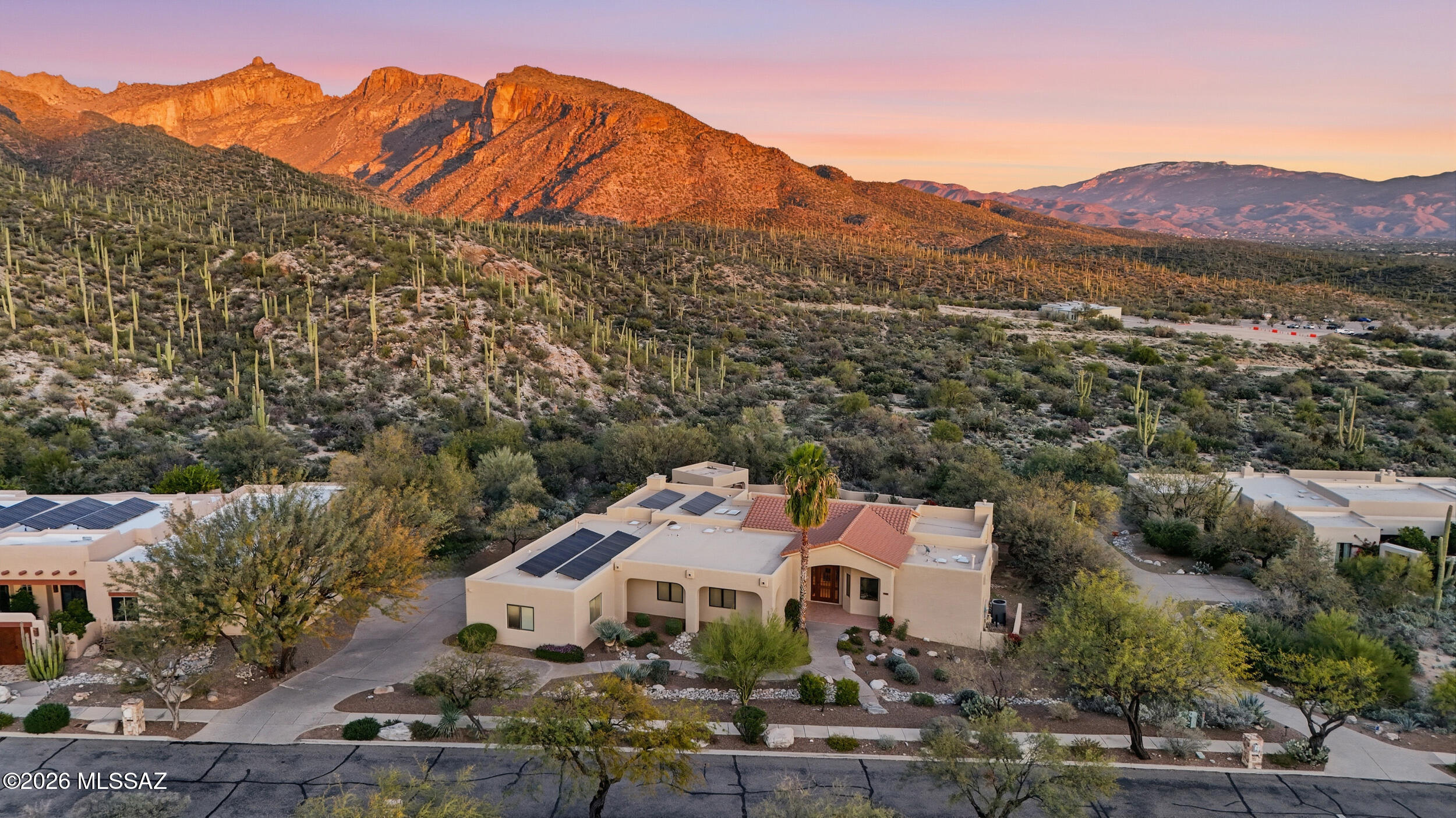 Located in a gated and coveted foothills setting near Sabino Canyon, this expansive 5-bed/3.5-bath home offers comfort and elevated entertaining. Light-filled living spaces feature indoor-outdoor flow. The kitchen is the centerpiece with updated appliances (June 2025) and large island. The primary suite showcases canyon and mountain views, FP, spa-inspired bath with soaking tub, and walk-in closet. A den adds flex space for office or hobbies. Split-bedroom floor plan with updated baths provides privacy for guests or multi-generational living. Enjoy a private outdoor oasis with a fully equipped outdoor kitchen plus pizza oven, pool, spa, and outdoor shower. Spacious three-car garage with EV charger.