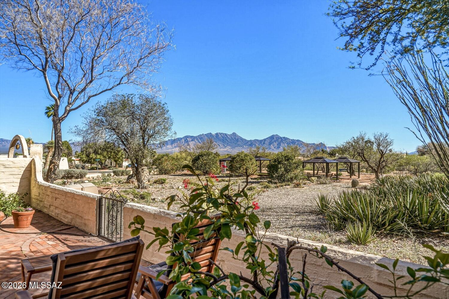 Enjoy relaxed desert living in this beautifully maintained 2 bedroom, 2 bath home with stunning views of the Santa Rita Mountains.  This light, bright and airy home has an open floor plan, creating a seamless flow between the living, dining and kitchen areas - perfect for everyday and entertaining.  Updates enhance both style and comfort. The covered patio is the perfect area to relax and enjoy breathtaking mountain views and peaceful surroundings that make Southern Arizona living so special. There is a spacious 2 can garage with a hobby workbench and storage. All furnishings and personal belongings included on inventory list convey with the property.  Most appliances have transferable warranties.New roof 2026 w/10 yr. warranty, A/C has performance plan maint., transferable pest warranty