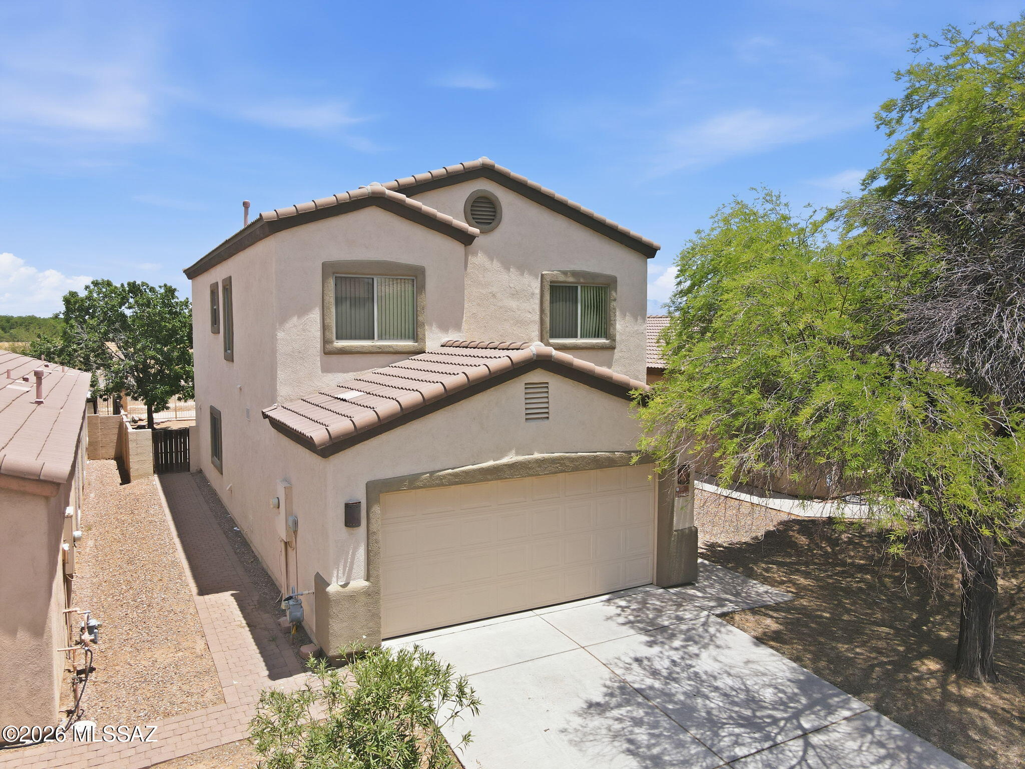 Exceptional 4-bedroom, 2.5-bath home in the Rancho Sahuarita community featuring mountain views, no rear neighbors, and views of the iconic pecan orchards. From the moment you enter, you'll appreciate the sightline to the lush orchards beyond. Tile flooring spans the downstairs, where an open great room seamlessly connects the living, dining, and kitchen areas. A private double-door office and convenient half bath complete the main level. Upstairs, the primary suite offers mountain views & a versatile bonus space perfect for a nursery, yoga area, or reading nook. 3 additional bedrooms & a full bath provide ample space. The backyard enjoys a premium location backing to open space with tranquil views toward the pecan groves. Whether you envision a garden, outdoor kitchen or pool, this space offers unlimited possibilities!