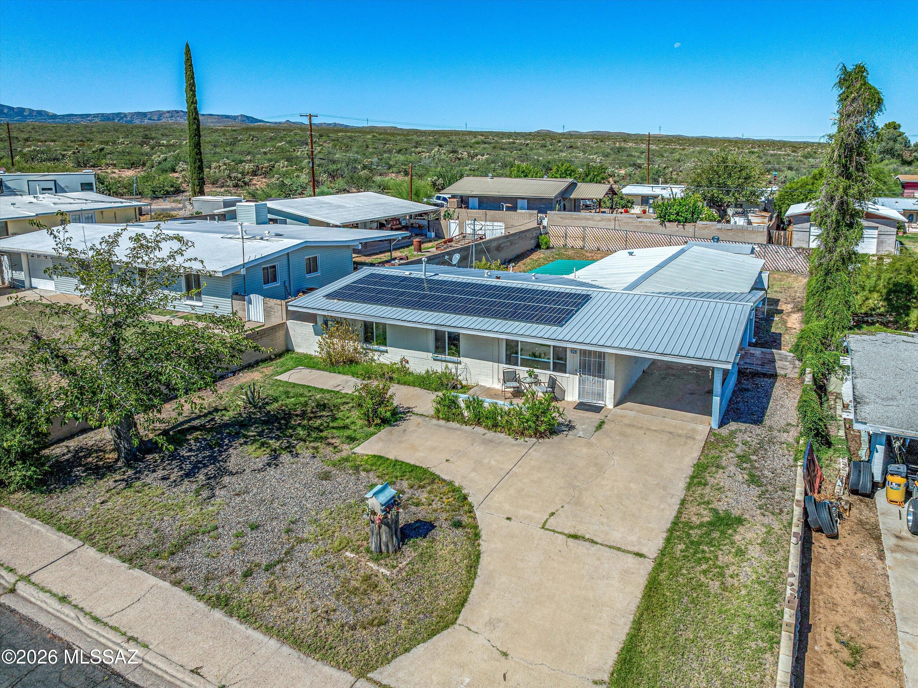 This 3-bedroom, 2-bath home has 2,169 sq ft of living space, with a metal roof and a solar system for lower energy bills. Out front, a covered carport and a front patio give you a shady spot to sit outside.

Inside, tile floors and ceiling fans run throughout. An addition expands the family room, a bright and spacious area for relaxing or entertaining. The kitchen opens to the dining area through a breakfast bar. It has a walk-in pantry, plenty of cabinets and a gas range. Both bathrooms are easy to use: one has a walk-in bathtub and the other a walk-in shower. There's also indoor laundry space.

Attached bonus rooms can serve as storage, a hobby space, a workshop or an office. The private backyard has room for a garden, outdoor living or whatever you have in mind.