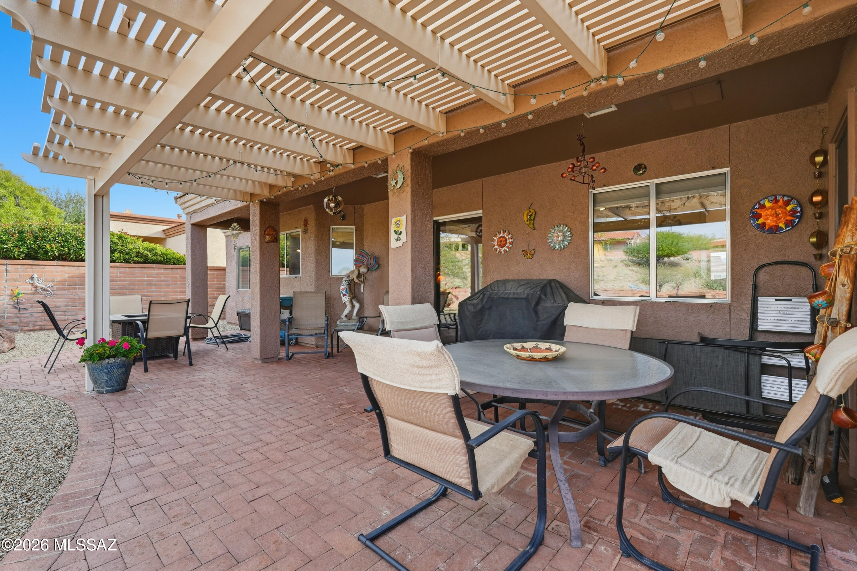 Set within a coveted 55+ golf course community, this beautifully maintained residence offers a refined blend of Southwestern charm, modern upgrades, and an elevated active adult lifestyle. Designed for comfort and ease, the home features single level living and a bright natural sunlight ideal for sophisticated entertaining or creative pursuits. 
An owned solar system delivers energy efficiency with predictable utility costs, complemented by a new roof and PEX plumbing--providing confidence and long term peace of mind. Thoughtful updates to water and electrical systems ensure the home is truly move in ready.
Indoor and outdoor living merge seamlessly through covered patio spaces and a pergola, inviting peaceful mornings and elegant evenings. The corner lot setting enhances privacy while capturing open, elevated mountain views amid low maintenance desert landscaping, perfectly suited for a lock and leave lifestyle.
Residents enjoy GV Recreation membership, offering resort style pools, fitness facilities, clubs, lifelong learning, and vibrant entertainment--curated for an active and social lifestyle.
Delivers timeless style, modern efficiency, and relaxed luxury in one of Green Valley's most desirable golf communities.