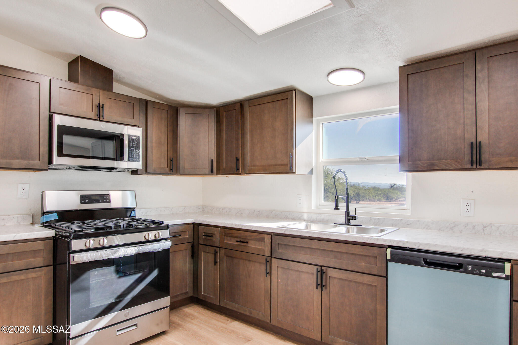 Move-in ready updated manufactured home on 4+ acres in Sierra Vista! Features a brand new roof, fresh interior/exterior paint, luxury plank flooring, and modern light fixtures. The kitchen boasts warm brown cabinets, new countertops, and stainless steel appliances. Refreshed bathrooms include new vanities and fixtures. Enjoy extensive outdoor space with a dedicated workshop/studio and 2 extra storage units. Schedule your tour today!