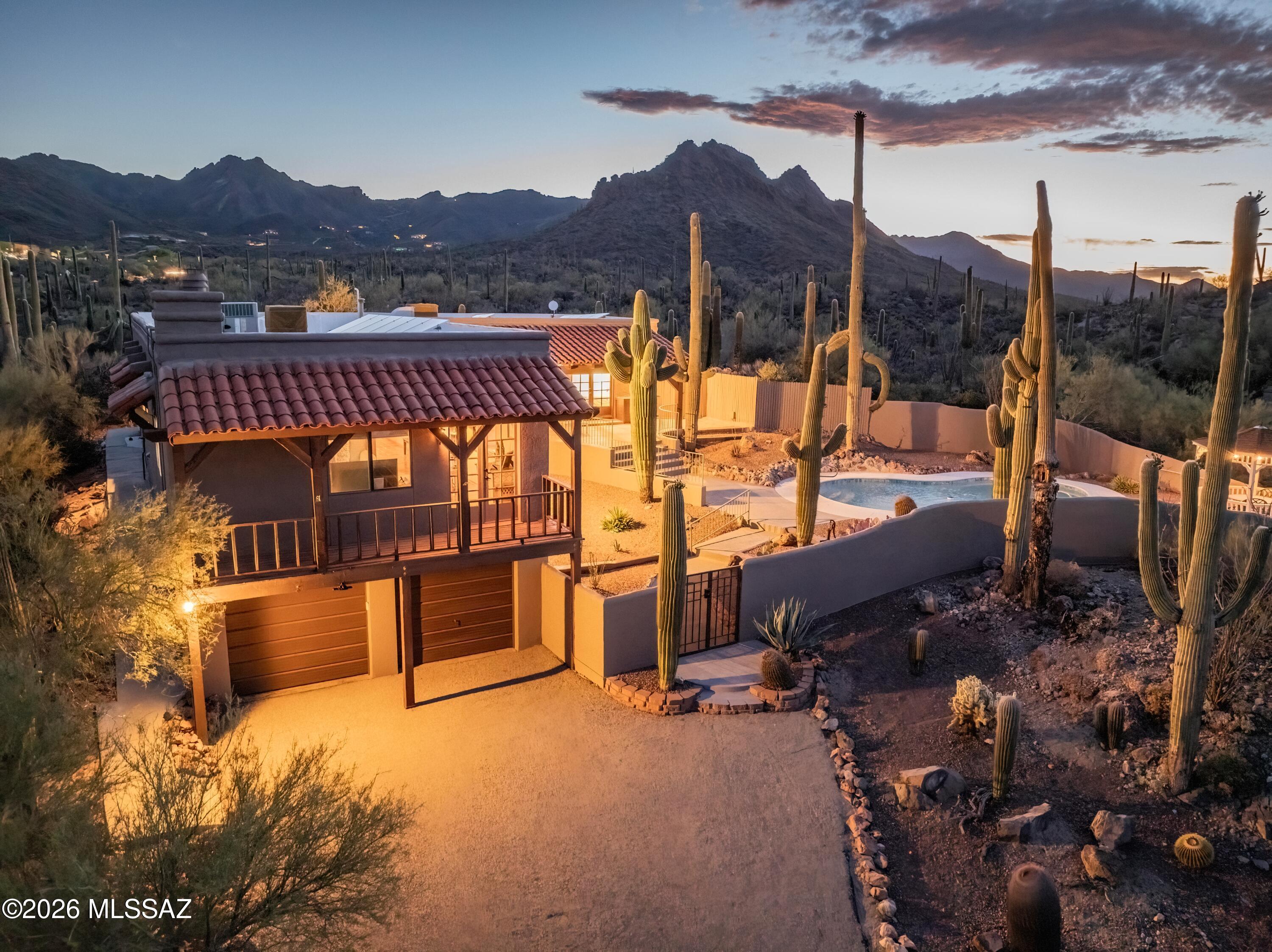 Welcome home to serene desert living on Tucson's coveted west side. Bordering Saguaro National Park, this stunning 2,252 sq. ft. residence offers unobstructed views, exceptional privacy, and a true connection to the surrounding desert landscape. Featuring 3 bedrooms and 2 bathrooms, the home is filled with natural light and showcases breathtaking desert vistas from every window. Enjoy spectacular sunrise and city views to the east and unforgettable sunset views to the west. Inside, peaceful mornings await beside the charming beehive fireplace, while sunny afternoons are best spent relaxing by the pool and taking in the tranquility of the desert surroundings. If you've been searching for peaceful living in one of Tucson's most sought-after locations, this property is not to be missed!