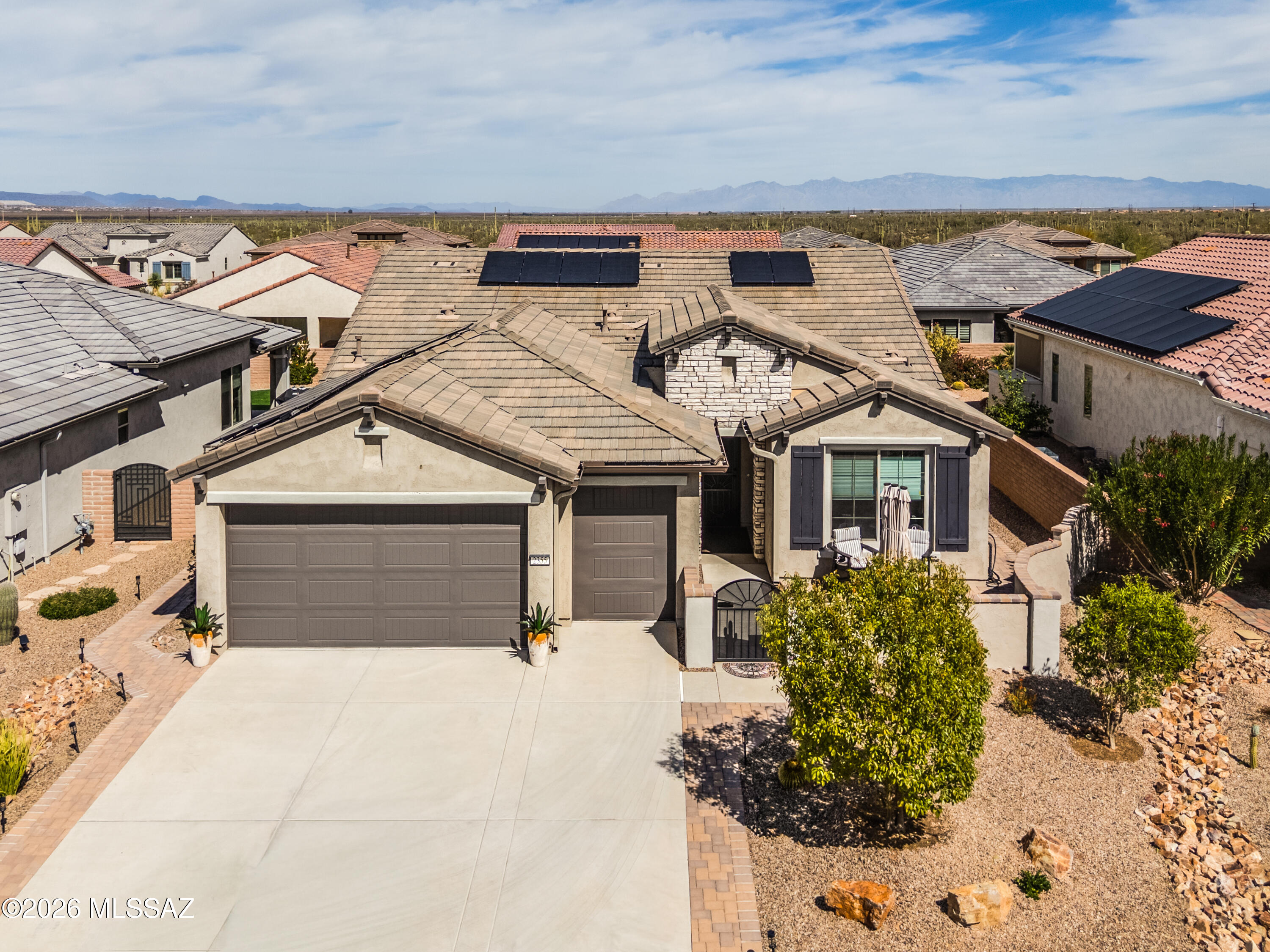 Welcome home to this beautifully upgraded 2-bedroom, 2.5-bath residence with a versatile den, built in 2022 and offering 1,808 sq ft of thoughtfully designed living space that blends comfort, style, and functionality.

Inside, you'll find an inviting layout enhanced by tall baseboards, ceiling fans throughout, elegant wooden blinds, and blackout thermal shades that provide both privacy and energy efficiency. The large primary suite includes an extended bath and closet to create a spacious retreat designed for comfort and relaxation. The guest bathroom features a classic porcelain tub, perfect for soaking after a long day.

The expanded laundry room offers added convenience with extra space and a built-in utility sink, while the garage has been extended four feet and includes a polyuret coating backed by a lifetime guarantee, overhead storage racks, a convenient man door, and a dedicated golf cart garage, providing exceptional storage and flexibility.

The home is also equipped with a go green, whole-house water conditioner, a transferrable solar lease, water spigots at every corner of the house, and an upgraded front entry door with decorative window, adding both convenience and curb appeal.

Step outside and enjoy a north facing outdoor living experience. A wraparound paver walkway leads from the front to the backyard, where a fully fenced and gated outdoor living area awaits. The patio is also finished with polyurethane coating, and electric sun shades allow you to enjoy the space comfortably year-round.

Surrounded by beautifully mature landscaping, the backyard oasis features palms, easy care turf, and productive citrus trees including grapefruit, tangelo, and lime, creating a private, serene environment perfect for relaxing or entertaining.
This exceptional home offers the ideal combination of modern upgrades, practical features, and inviting indoor-outdoor living--ready for you to move in and enjoy.