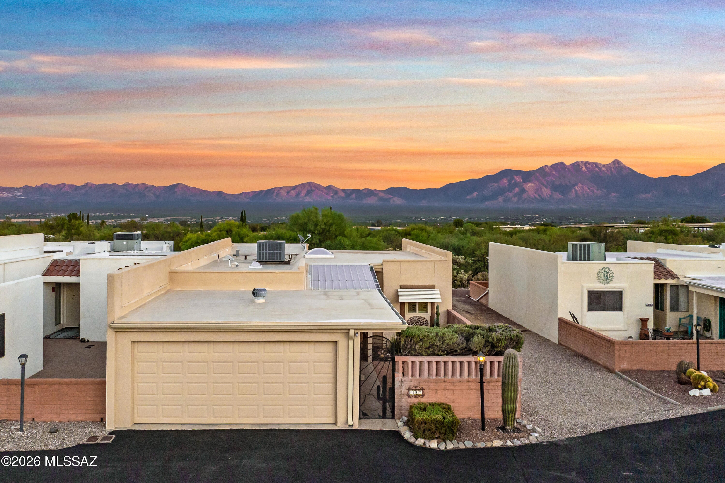 Some views are worth waiting for and this one is truly special. Perched on an elevated lot with no rear neighbors directly behind you, this end unit townhouse showcases sweeping panoramic mountain views that change with every Southern Arizona sunrise and sunset. A private front courtyard with an epoxy coated walkway sets a warm welcome before you even step inside. The home offers 2 bedrooms, 2 baths and a versatile den ideal for an office, guest retreat or creative space. Skylights and an atrium bathe the interior in natural light, while the screened Arizona room invites you to linger over morning coffee or watch the evening glow settle over the mountains. Lovingly maintained with newer windows, skylights, HVAC, water heater, refrigerator, W/D and more. This home lets you skip the to do list and start living the relaxed, low maintenance lifestyle you've been dreaming of. The 2 car garage includes extra storage for golf clubs, bikes and seasonal treasures. Your HOA fees include the community's own recreation center with a sparkling pool, hot tub, tennis and pickleball courts, library, kiln, shuffleboard and more. GVR is not required but available. Views like this are rare at this price point, so come experience it for yourself!