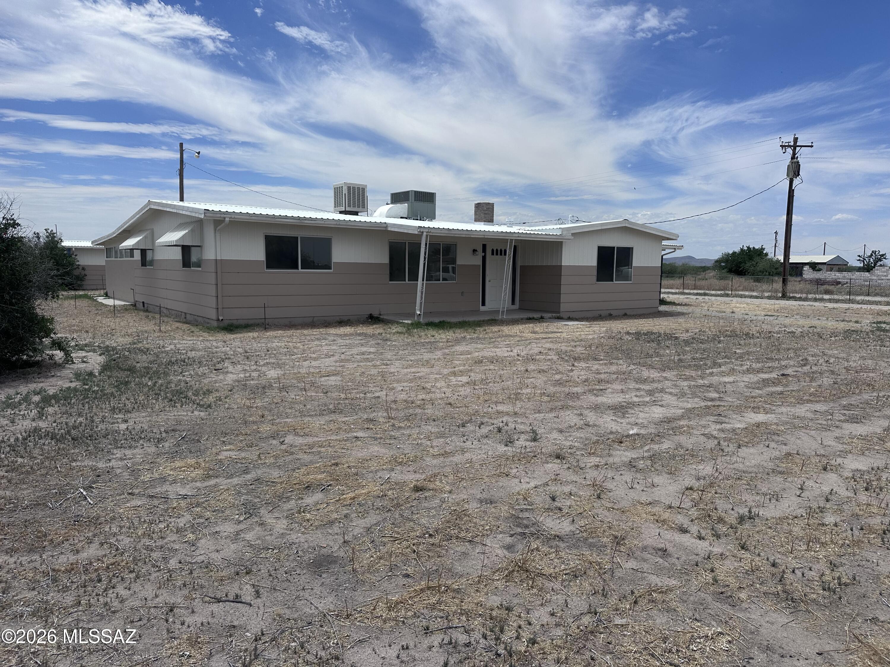 Nestled on a fully fenced 1-acre lot in Willcox, this beautifully remodeled 1,536 sq. ft. home offers the perfect blend of comfort, style, and functionality. Featuring 3 bedrooms, 2 bathrooms, and a versatile bonus room, there is plenty of space for a home office, gym, playroom, or guest area. The updated kitchen showcases granite countertops and ample cabinetry, while the dining room is warmed by a charming wood-burning fireplace, creating a cozy and inviting space for meals and gatherings. Outside, you'll find a covered carport, detached workshop, and abundant space for RV parking, animals, gardening, or future improvements. Enjoy the freedom of country living with modern updates already in place in peaceful Willcox.