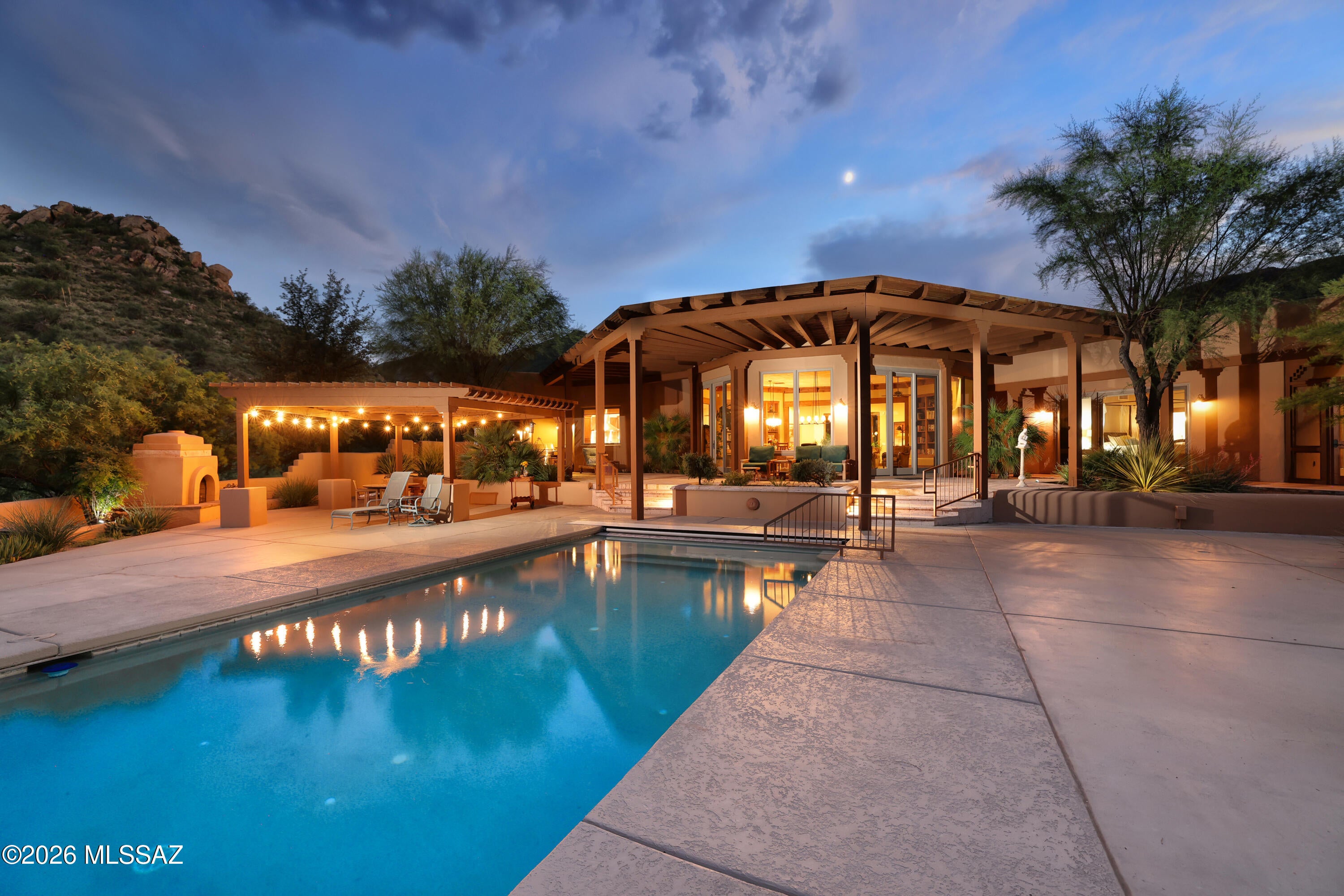 Set amid the serene beauty of Morning Star Ranch, near the charming village of Tubac, this distinctive 72-acre estate blends Santa Barbara sophistication with the timeless character of the Southwest. Custom built in 2006, the property encompasses 4,715-sf, including a 3,453-sf main residence and a separate 1,262-sf guest house. Framed by magnificent mountain vistas, the setting captures spectacular sunrises, luminous sunsets and extraordinary star-filled nights. Designed for gracious living & effortless entertaining, the residence features four ensuite bedrooms, & 4.5 baths. Santa Barbara-style stucco, generous windows, soaring ceilings, architectural detailing, & extensive landscaping create an elegant yet distinctly Southwestern sense of place. Check out the music video and Virtual Tours At the heart of the home, the dramatic great room rises approximately 14 feet, crowned by a distinctive decagonal ceiling accented with substantial wood beams. Walls of windows open toward the northeast and the infinity-edge pool beyond, while beautifully crafted Ramada-inspired eyebrows filter the Arizona sunlight and add architectural depth and character.

The chef's kitchen is exceptionally appointed with a stainless-steel Sub-Zero refrigerator/freezer, Wolf six-burner gas range with two ovens and griddle, stainless-steel hood, two Bosch dishwashers, and two sinks. A generous breakfast nook provides an inviting setting for casual dining, morning coffee, or intimate gatherings. Extending directly from the kitchen and breakfast nook is a substantial Butler's pantry, thoughtfully designed for both entertaining and everyday functionality. It features a Scotsman ice maker, wet bar, an additional Sub-Zero refrigerator/freezer, extensive walls of cabinetry, and a built-in desk--providing remarkable preparation, serving, storage, and workspace.

The primary suite offers a private retreat with a luxurious ensuite bath featuring dual sinks, a walk-in shower, and a towel warmer. Throughout the residence, four gas fireplaces create warmth and ambiance, thoughtfully placed in the great room, primary suite, kitchen nook, and a woodburning fireplace at the outdoor gathering area near the backyard Ramada.

Outdoor living is an integral part of the home's design. The infinity-edge swimming pool creates a dramatic focal point against the surrounding mountain panorama, while covered patios, Ramada-style outdoor spaces, mature landscaping, and multiple gathering areas extend the living experience into the landscape. From leisurely afternoons poolside to evenings gathered around the outdoor fireplace, the setting is equally captivating beneath the brilliant Arizona sun or an expansive canopy of stars.

The separate 1,262-square-foot guest house offers a beautifully appointed private retreat, featuring a great room, kitchen, dining area, and a thoughtful split-bedroom design with two bedrooms, both with its own ensuite bath and one with a private patio. Ideal for extended family, guests, multigenerational living, or simply creating a peaceful space apart from the main residence, the guest house adds a rare degree of flexibility to the estate.

A remarkable four-car tandem garage with approximately 14-foot-high clearance provides abundant room for vehicles, recreational equipment, RVs, workshop space, or storage. A side covered patio/storage area further enhances the property's utility, with potential for additional covered parking. A helicopter pad is available for medic-emergencies, and the neighborhood is equine friendly.

This is a rare Southwestern estate where architecture, acreage, privacy, dramatic mountain scenery, and sophisticated indoor-outdoor living converge. Close to the historic artist colony of Tubac with a thriving art scene, restaurants and boutique shops, 150 Canyon Pass Court offers an extraordinary opportunity to experience a refined Arizona lifestyle surrounded by beauty, serenity, and wide-open skies.