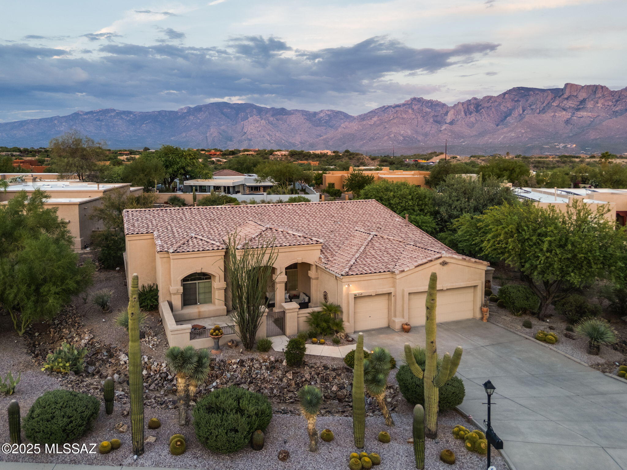 Exquisite home in Oro Valley's sought-after Tangerine Heights neighborhood. Greatroom floorplan anchored by a gourmet kitchen with ample cabinetry, rosewood granite stone counters, 5-burner gas range, large island & SS appliances. Walls of windows offer natural light & views of your outdoor oasis: pebble tec pool with waterfall & spa, multiple seating areas, low maintenance xeriscape, landscape lighting & a cozy chiminea fireplace for the cool desert nights. Primary suite offers split walk-in closets, dual vanities with make-up station, granite counters, soaker tub & deep walk-in shower.  Roof & WH replaced 2023. Uniquely shaped 0.48 acre lot allows privacy from neighbors with views of Pusch Ridge. Prime location close to bike paths, hiking, schools, golf, shopping & top restaurants