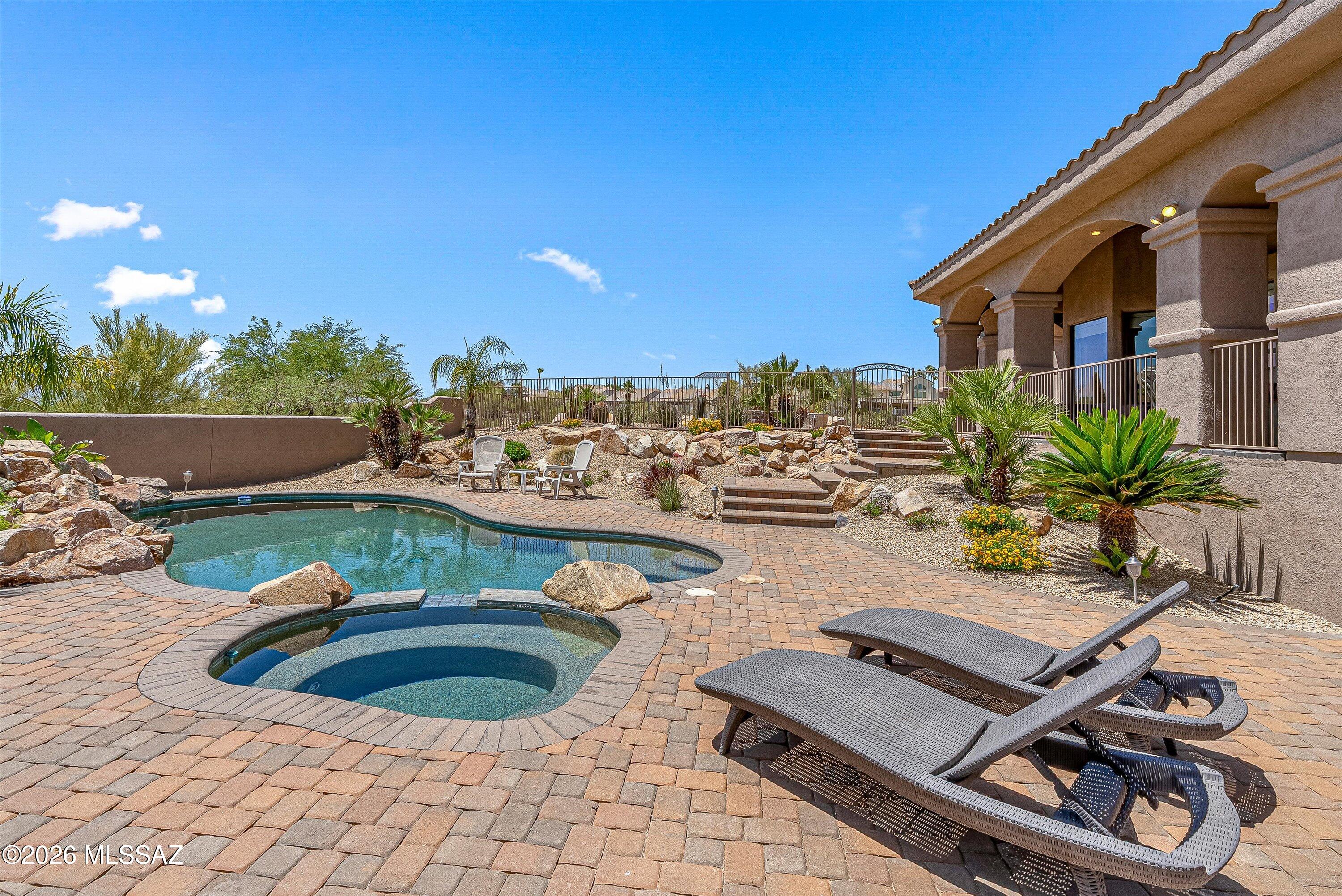 First time on the market, this luxury residence is perfectly positioned on the largest lot in the community, offering unmatched privacy and stunning views of the mountains, city lights, and golf course. You will find an extremely large office with exterior access for your home business. The home features a split floor plan with towering ceilings and an open, airy layout filled with natural light. Step outside to your own private retreat, an expansive patio ideal for entertaining or relaxing in complete seclusion, complemented by a sparkling pool and terraced landscaping. Additional highlights include a abundant storage including a spacious 3-car garage with sleek epoxy flooring and an enormous walk up storage area above the garage.  Close to dining, top  schools and outdoor activities.