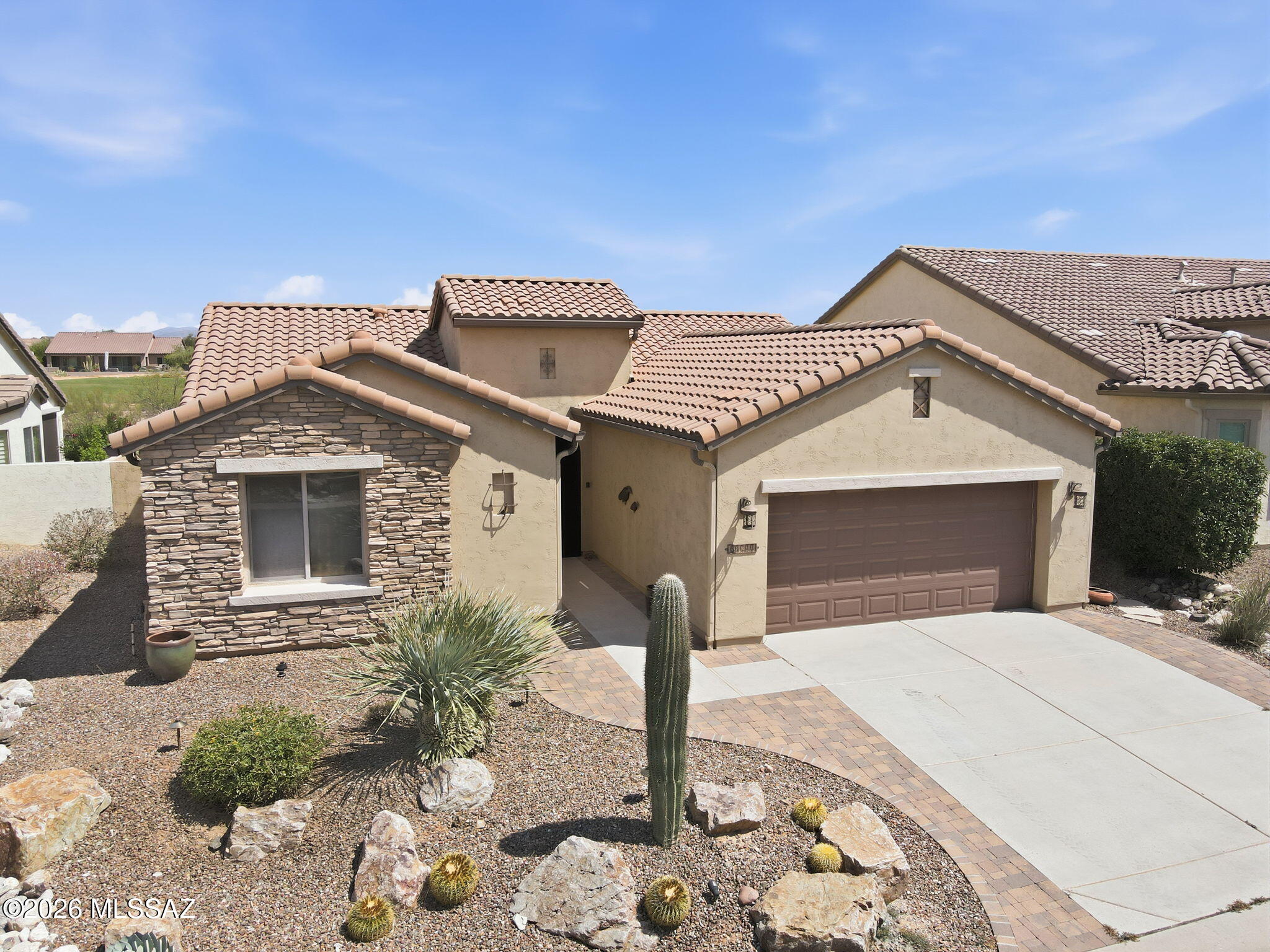 Experience luxury resort living in this stunning ''The Bella'' floor plan SaddleBrooke Ranch home! Boasting an open and flexible floor plan, this 2BR/2BA layout features a dedicated den ideal for an office, hobby room, or guest space. The kitchen is a chef's delight, complete with a center island, stainless steel appliances, granite countertops, and a bright dining area.
The main living space flows effortlessly through sliding glass doors to an outdoor entertainer's dream. Enjoy an expansive covered patio, a separate fire pit area, and beautiful desert landscaping that backs up directly to the 11th Fairway of the SaddleBrooke Ranch Golf Course. Complete with a 2-car garage and access to world-class community amenities, this home is ready for you to make it your own!