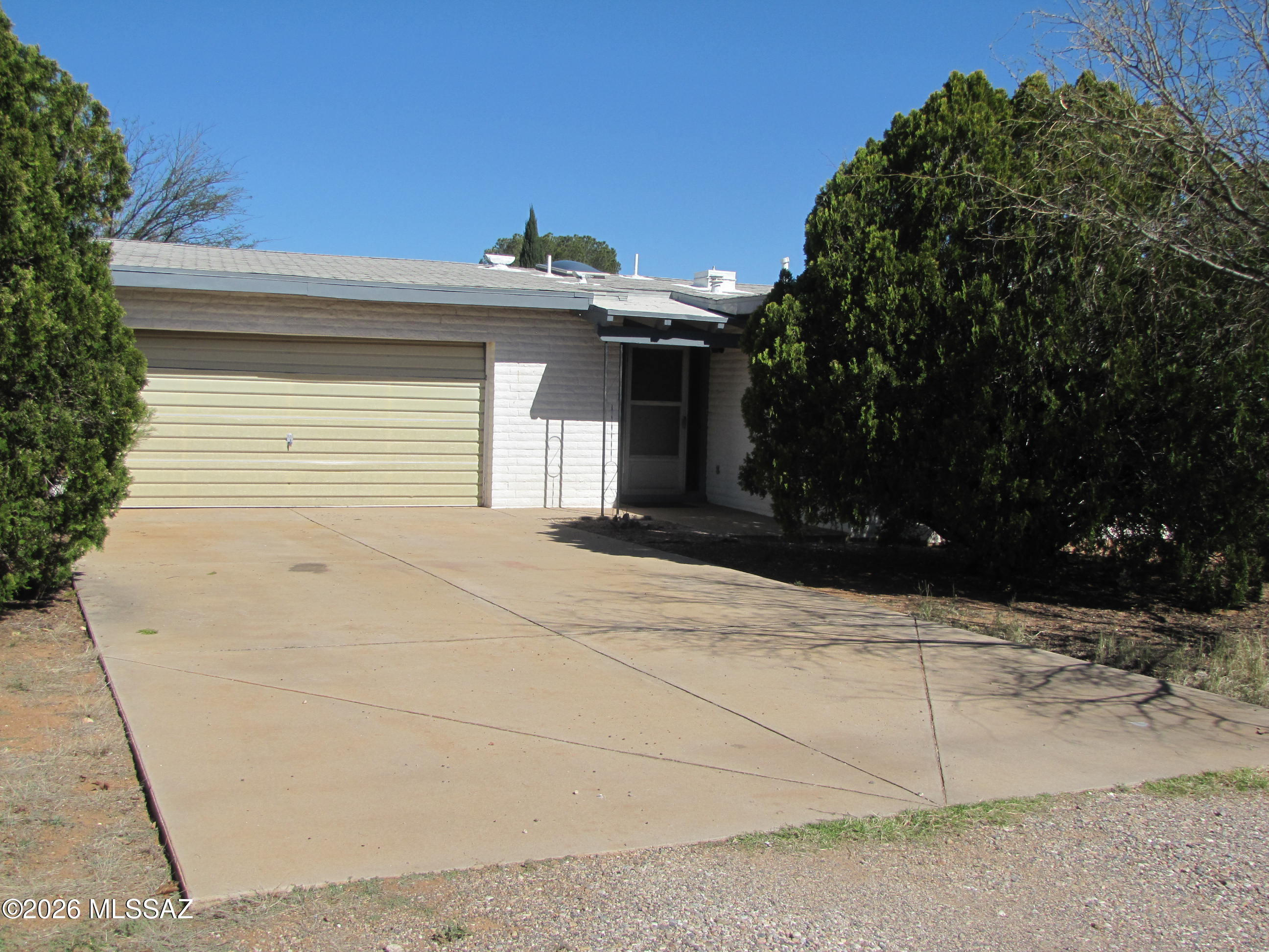 Slump block 2BR/2Ba house located in the friendly village of Sunsites. Covered front entryway. Living room could be used as formal dining room. Skylights in kitchen and living room. Family room leads onto covered back patio. Backyard has chain link fencing, one finished greenhouse and one partially finished greenhouse; alley on two sides. Attached 2-car garage with storage and workbench. Shopping, eating and other amenities located nearby. Quick access to Hwy 191. Needs some TLC and upgrades.