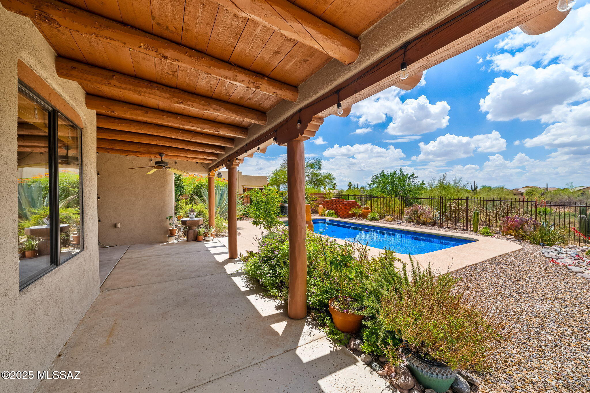 Beautiful 3bdr/2ba Southwestern style home! This home features Satillo tile floors throughout, wood beamed ceilings, open/bright Living room w/gas fireplace, dining room, ceiling fans, two car garage, fenced backyard and water softener. Spacious kitchen w/stainless steel appliances, induction cook-top, island, Granite counters and casual dining area overlooking the backyard. Primary bedroom w/ensuite offers dual vanities, garden tub and walk-in shower. Split bedroom floorplan, bedroom 2 w/Murphy bed and built-ins would make a great office/bedroom! The backyard is a MUST SEE w/wrap-around covered patio, fruit tree, gardens, mountain views and sparkling pool w/service included. Landscape services are also included. EMS Realty only represents the Landlord in this listing