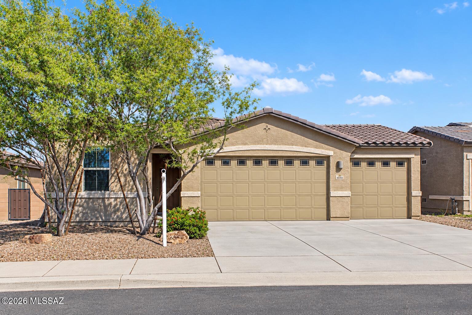 Welcome to Gladden Farms! This spacious 4-bedroom, 2-bathroom home, built in 2020, offers modern comfort and a highly desirable 3-car garage. Fresh interior paint gives the home a refreshed feel, making it move-in ready and waiting for its next owner. Enjoy all that this sought-after Marana community has to offer, including miles of walking trails, scenic greenbelts, beautifully maintained parks, and inviting open spaces. Experience the perfect blend of comfortable living and an active outdoor lifestyle. A must see!