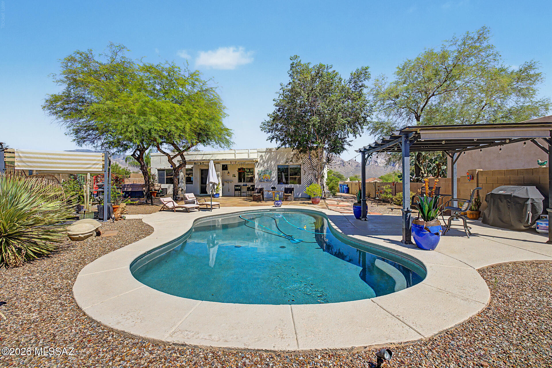 SPLASH INTO SUMMER! Magnificent Oasis in the Desert Located in the Heart of Oro Valley.  Impeccable Backyard Incredibly Detailed for Relaxation. Pebble Tech Pool, Hot Tub, Ramadas, Extended Covered Patio, Specialized Decorator Concrete for Extra Flair (Rigos)! Updated Kitchen, Granite Counter Tops, All Appls.  Extensive Ceramic Tile, Upgraded Designer Fixtures.  Primary Bath has Newly Updated Shower and Expanded Closet! Primary and Main Baths have Quartz Countertops.  Seller Owns Solar System, Ring System and Automation!  You will be Proud to call this Fashionably Chic Home Your Own!