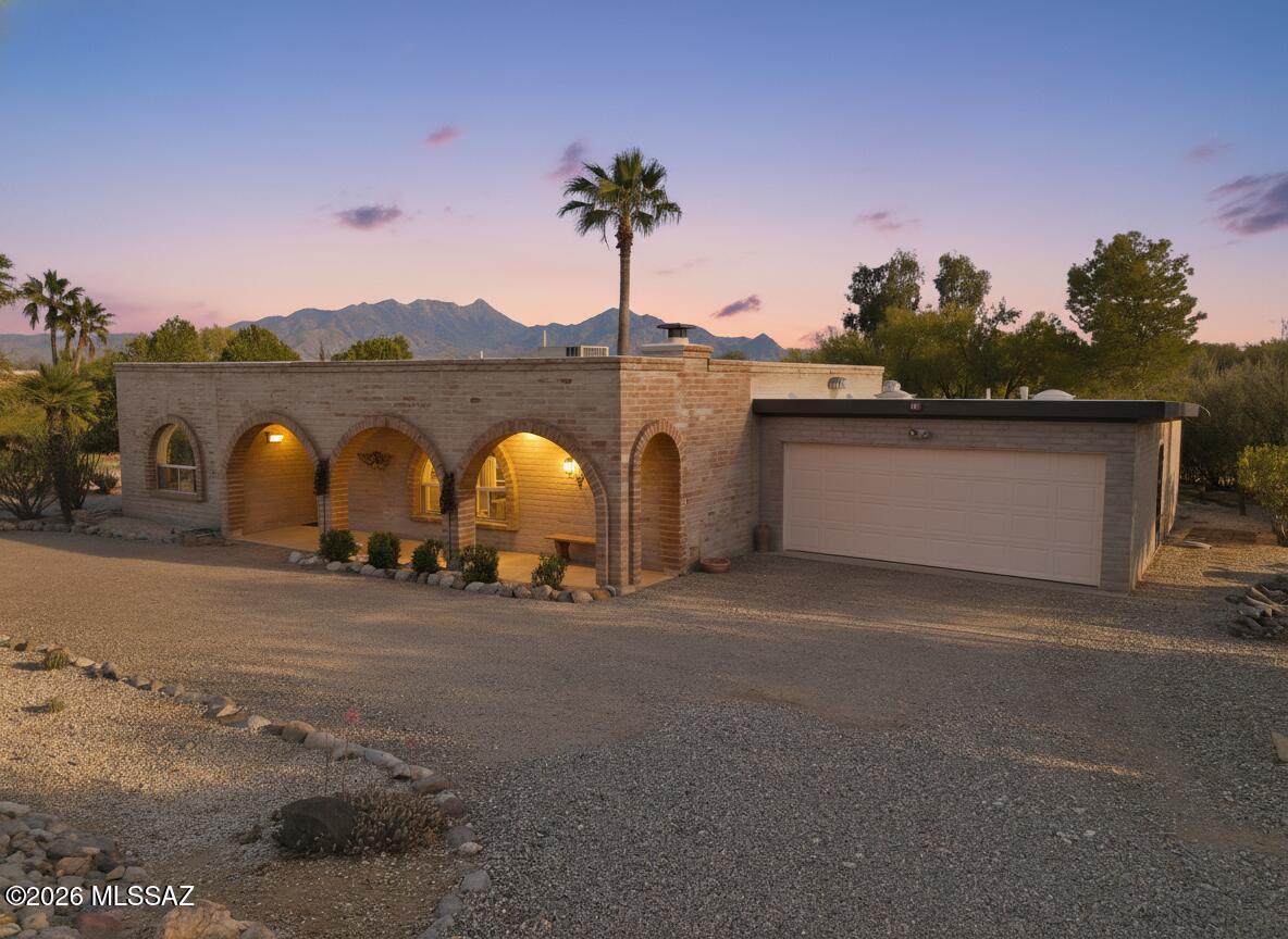 Tucked behind the timeless charm of authentic slump block and graceful arches, this rare 1.22-acre retreat sits in the heart of town in the desirable ACRES neighborhood, offering the kind of privacy and elbow room that simply doesn't exist anymore. NO HOA and plenty of room to park the RV, all terrain vehicles, and all of the other toys -- and it comes furnished, making it move-in ready from day one.

A wall of windows in the Arizona Room looks out to the mountains and the spacious back living area. Step inside and feel the warmth of a roaring fireplace in the great room, the kind that anchors a home and draws everyone in. The open kitchen flows seamlessly into the living spaces, making it as easy to cook for a crowd as it is to enjoy a quiet night in. The fact that you're right in the middle of town makes it nothing short of extraordinary. Restaurants, shops, and conveniences are minutes away, yet the moment you pull through your own gate, the world quiets down. There are properties, and then there are places that change the way you live. Acreage, privacy, and mountain views -- right in the center of it all. This is your desert dream. Come claim it.