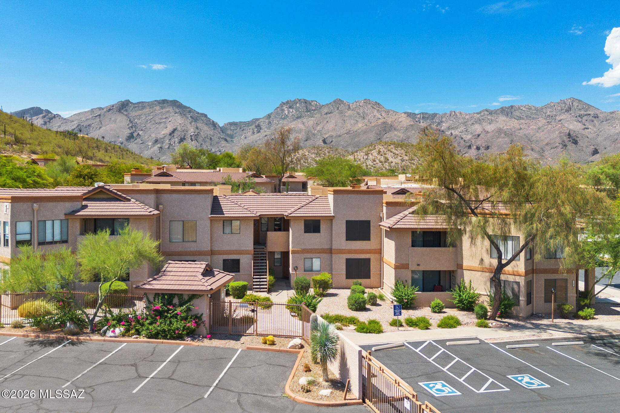 Best deal in the Foothills! This 2 bedroom/2 bathroom home has been updated with all the finest touches! New LVP Flooring (no carpet here!), New Fixtures, New Decor light switches and outlets, All NEW LG Stainless Steel appliances, Granite Counters, New two-tone paint & so much more has been done! Pool and Mountain Views from a North facing balcony.  Gated community with one covered parking spot making it easy to lock up and go! Catalina Foothills school district too!  What a dream! Rentals are allowed here- 30 day min. HOA includes: Tennis courts, Pool, Spa, Gym, Trash, Roof, Landscaping, Fire protection and Structural insurance.  This is one of the best locations and value in the community!  Come see it today!!