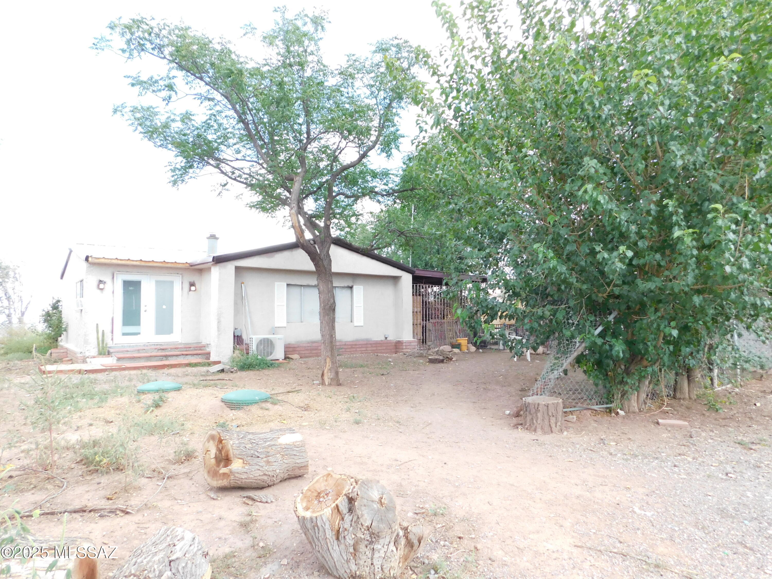 Enchanting Hobby Farm Retreat with EXPANSIVE 3 BR/2 BA Main House -Private well AND City water* oversized garage/workshop + additional building for guests or hobbies or residential business - Modern Upgrades & Endless Possibilities! Discover your slice of paradise with this beautiful Property! 2023-2025 RENOVATIONS INCLUDE: New septic system (10/2022), private well has new electrical, expansive window and door replacements, and a stunning new back deck perfect for family BBQs or al fresco dining under the stars. Versatile Outbuildings: A spacious workshop with a solid foundation and ample outlets. Another large building (needs some TLC) perfect for guest home or residential business. Many gardens and chicken coops. THIS HAS MANY SITE BUILT ADDITIONS, BUT IS A 1971 MANUFACTURED HOME HIGHLIGHTS:

PRIVATE WELL and city water
New Septic 2022
New Electrical Main Box in Master Bedroom
New Electrical for Private Well
New Appliances
New Bathroom vanities in both Bathrooms
New Cabinets in Kitchen
Upgraded ceramic tile in the Arizona Room
New Mini Split installed in Family Room
Working & incredible antique wood-burning cooking stove
Stalls with tackroom/barn space
Over 40 fruit trees/bushes, including Asian Pear, Fig, blackberry bush
Garden areas & chicken coop
New Deck off the home
2-4 car garage/workshop
Additional building can be a guest house, a residential business, or office
Very short walking distance to the award-winning McNeal Elementary
The main house has incredible and expansive floor plan
The Master Suite has a private door to the deck
New dual-pane windows and doors

Welcome Home!!