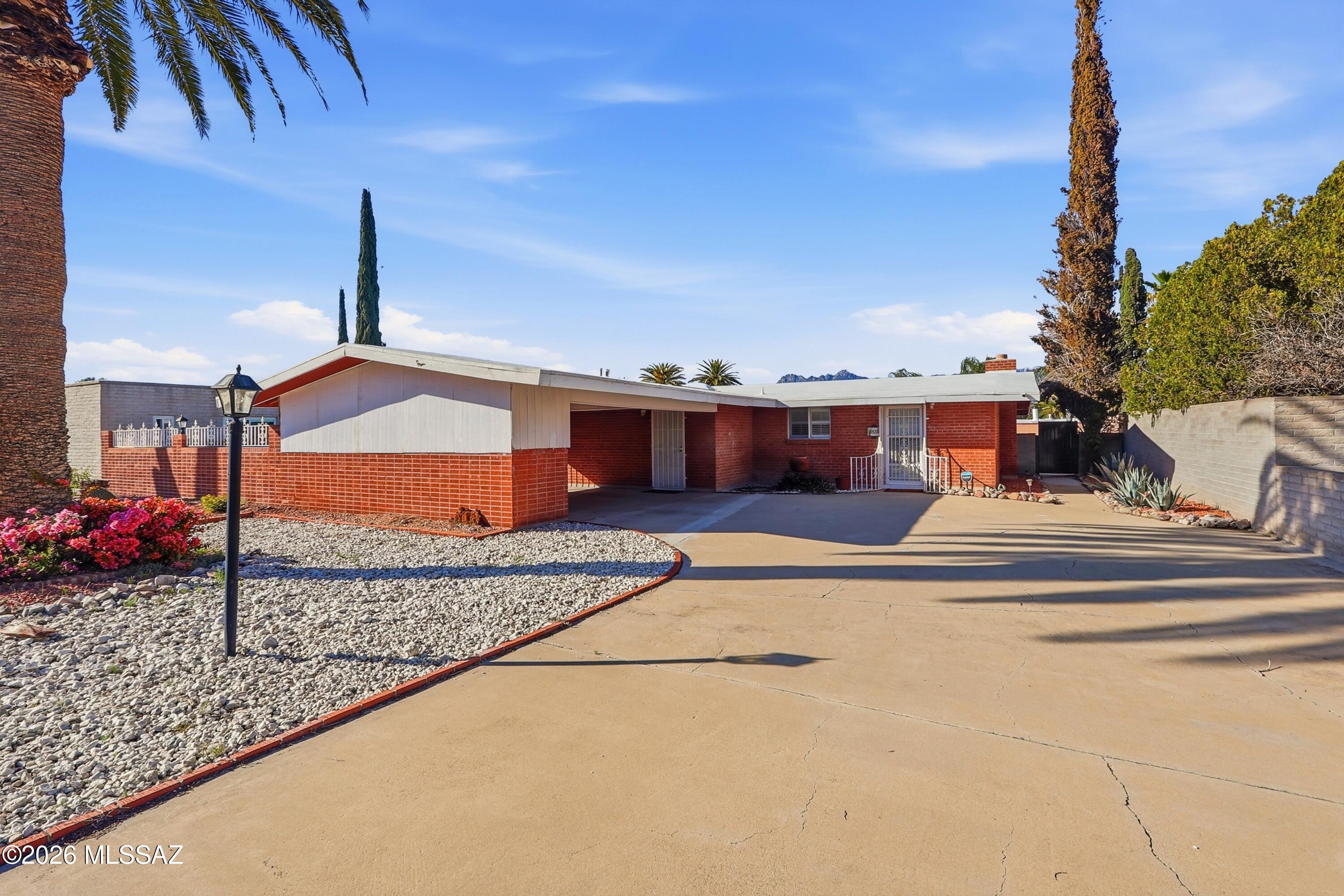 Welcome to 8925 E. Bellevue Street, ideally located just north of Speedway Blvd and east of Camino Seco on Tucson's desirable far east side. This well-maintained 3-bedroom, 2-bath brick home offers 1,624 sq ft, central A/C, gas heat, family room, wood-burning fireplace, and a beautifully updated interior with new carpet, paint, lighting, and upgraded baths with granite panels. The backyard is a true retreat--fenced pool area, covered patio, brick BBQ, and stunning Catalina Mountain views. Complete with citrus trees, double carport, and included appliances. Minutes to the University of Arizona and Davis-Monthan AFB.