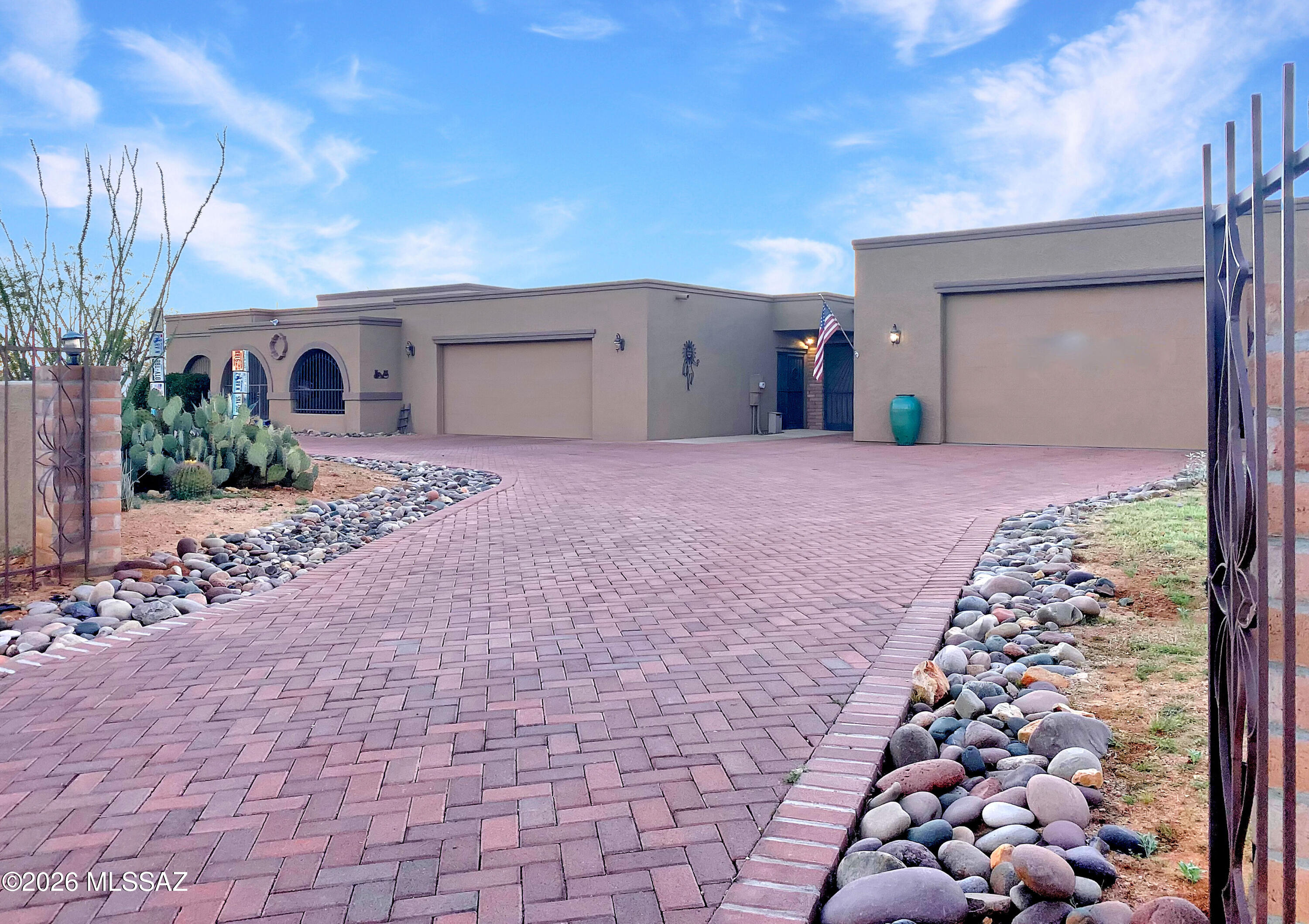 An Oasis in the Desert! Green Valley Acres is a NO HOA community. Discover this wonderful home on 1.23 Acres! Filled with natural light, this 2-Bdrm, 2-Bath home features a built-in office that can be converted to a third bedroom. Enjoy an open kitchen and dining area complemented by a cozy separate great room. Relax on full-length patios that offer breathtaking views of the Santa Rita Mountains. A large attached two car garage with golf cart space has two double closets on each side. The detached garage (shop) measures 26x40 and includes a 9x12 work area plus a 48 sq ft walk-in closet, offering ample space for all your projects with plenty of storage throughout. The lot, unlike many in The Acres, is completely useable and could accommodate four RVs or up to 20 cars. The ACRE-PLUS lot also offers ample room for entertaining, featuring an outdoor fireplace and a BBQ. The spacious master suite includes exterior access, a walk-in closet, a jetted tub, and a separate shower, making it a perfect retreat. Inside, you'll find 9-foot ceilings, tiled wet areas, and generous kitchen, dining, and living spaces. Brick and rock driveways make guest and RV parking easy and convenient. Beautiful low-maintenance desert landscaping and low annual utility costs thanks to exterior 10 inch walls complete this inviting home. It offers the perfect combination of peace and privacy, yet is only a mile from shopping and amenities. No Green Valley Recreation Fees (GVR) and no HOA restrictions in this all-ages community. HURRY TO SEE THIS SPECIAL HOME!