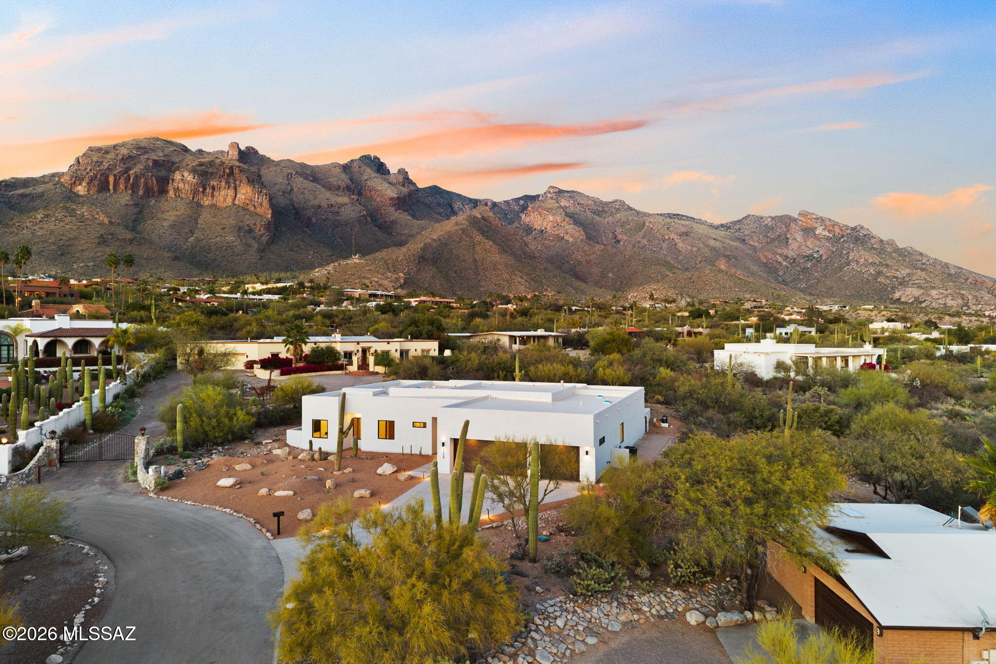 Experience unparalleled modern luxury in this stunning new construction home, nestled in the picturesque Catalina Foothills on a private cul-de-sac with breathtaking mountain vistas and sparkling city views.
Offering 3,584 sq ft of meticulously designed living space, the home showcases elegant porcelain tile flooring, custom cabinetry, and refined, high-end finishes throughout. The gourmet kitchen is a chef's dream, featuring top-of-the-line Thermador appliances, a spacious island, and a walk-in pantry, all seamlessly flowing into the open-concept great room. Anchored by a sleek fireplace and expansive sliding doors, the living space is designed for effortless indoor-outdoor living and entertaining.Owner is licensed to sell real estate in Arizona. The thoughtfully designed split floor plan includes 4 spacious bedrooms, each with its own ensuite bath, plus a dedicated office and a total of 4.5 bathrooms. The luxurious primary suite offers his and hers  walk-in closets and a spa-inspired bath, creating a true private retreat. Step outside to the covered patio and pool area, where panoramic views provide a stunning backdrop for relaxation and gatherings, enhanced by features such as an outdoor shower. An oversized 3-car garage adds convenience and functionality. Located within the highly regarded Catalina Foothills School District and minutes from La Encantada, St. Philip's Plaza, and premier hiking and biking trails, this home blends privacy, luxury, and accessibility.